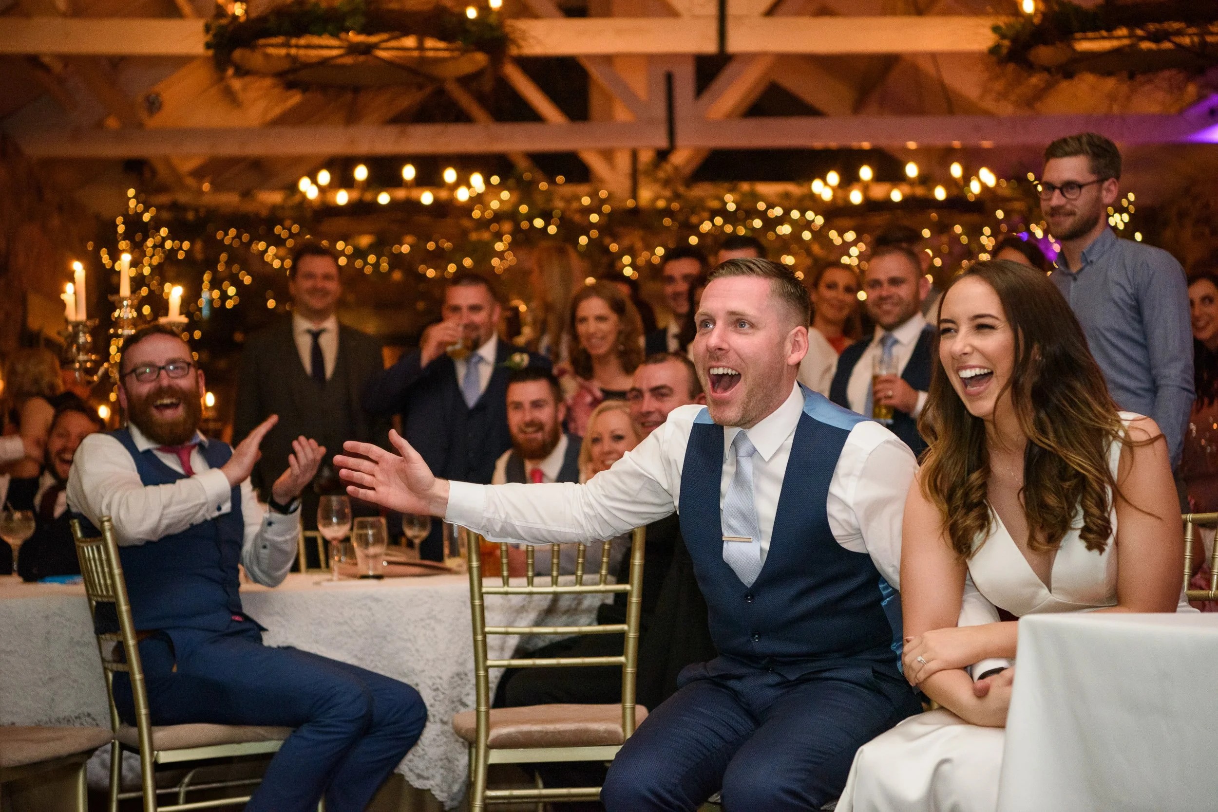 Wedding Photography Meath – guests reacting to slideshow during reception at Ballymagarvey Village
