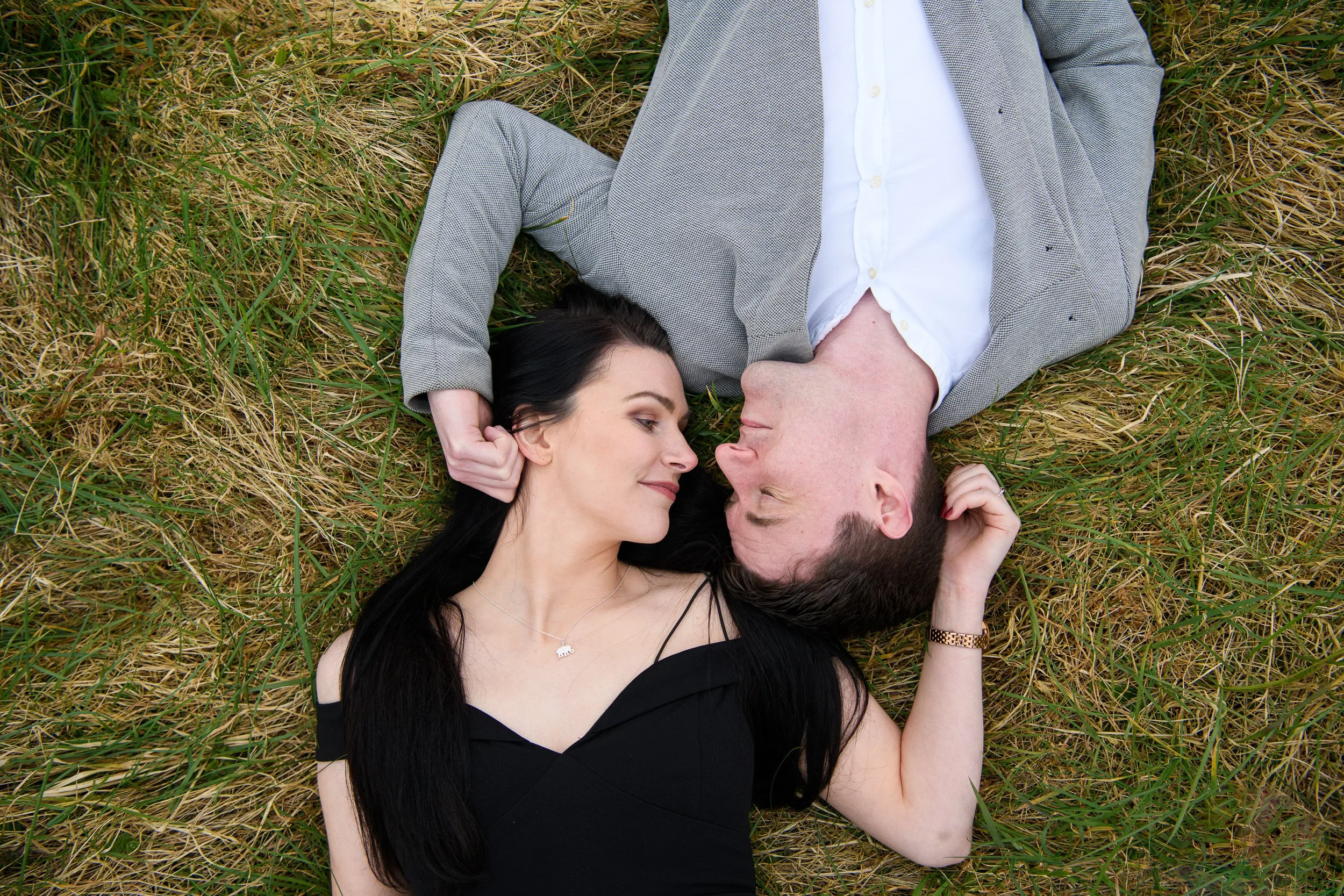 Engagement Photography Ireland – couple lying on grass with natural connection