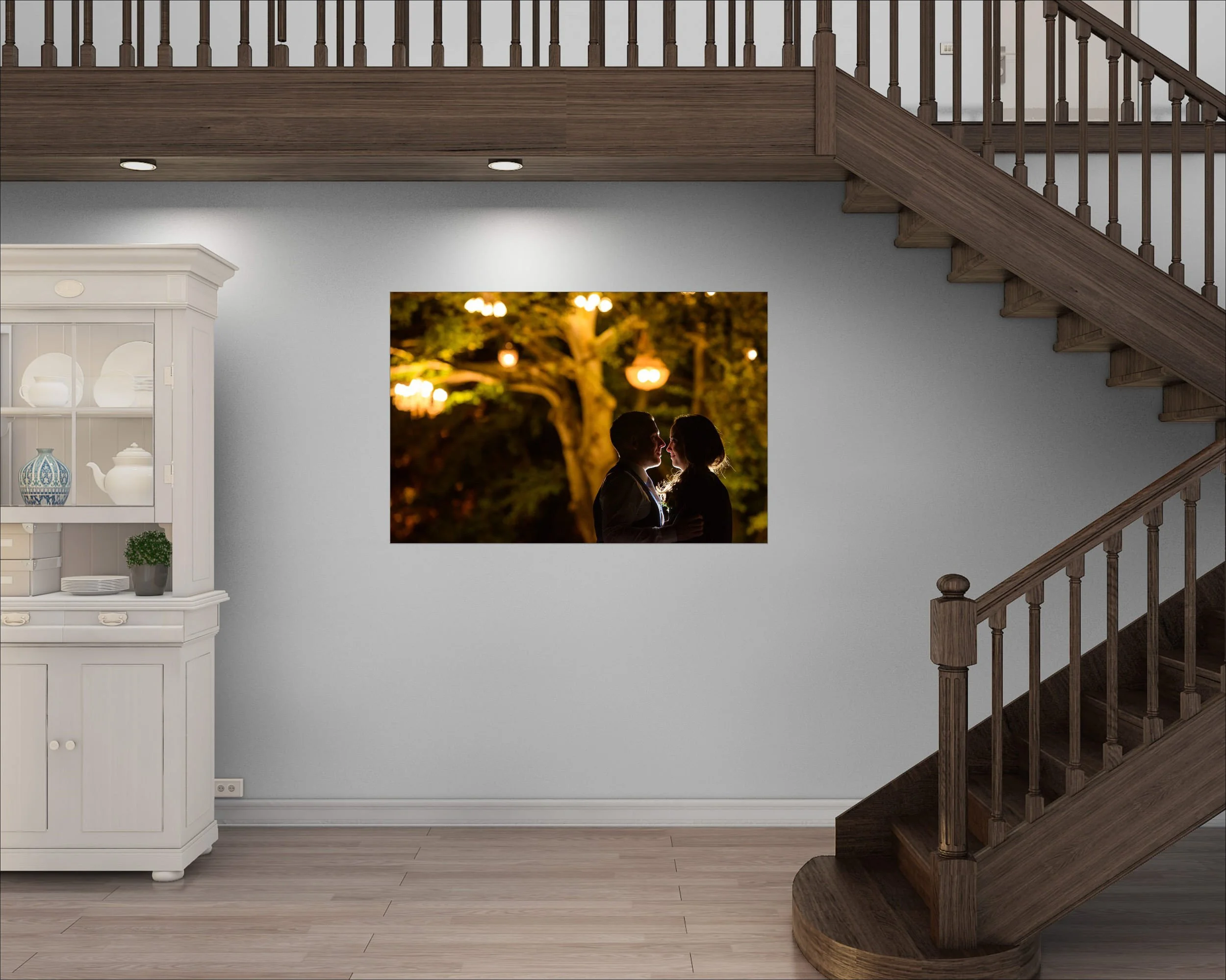 Framed photograph of a couple displayed on a wall near a staircase in a home interior.
