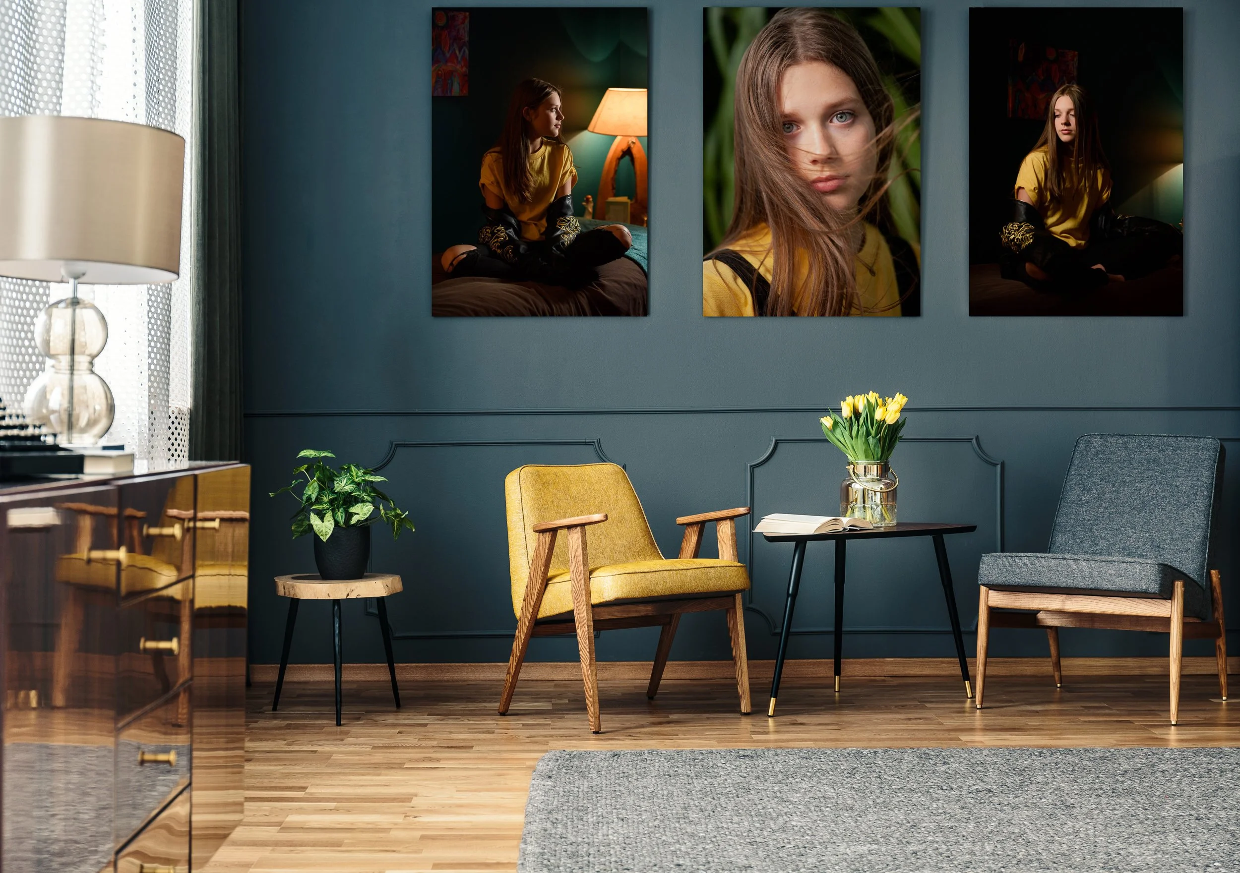 Living room with dark green walls, framed portrait artwork, and modern furniture styled with natural light.
