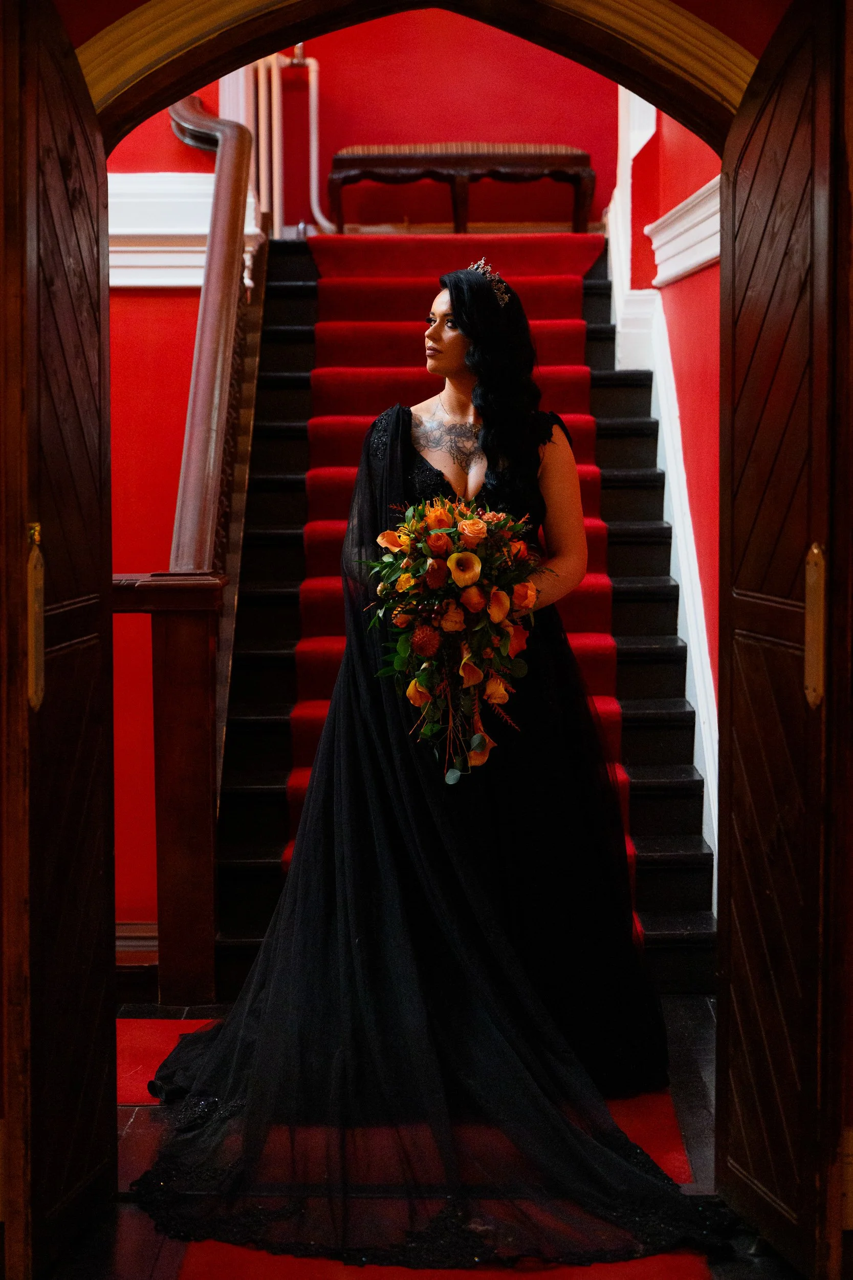 Wedding Photography Ireland – Bride in black dress on staircase with bold colour styling in Kinnitty Castle 
