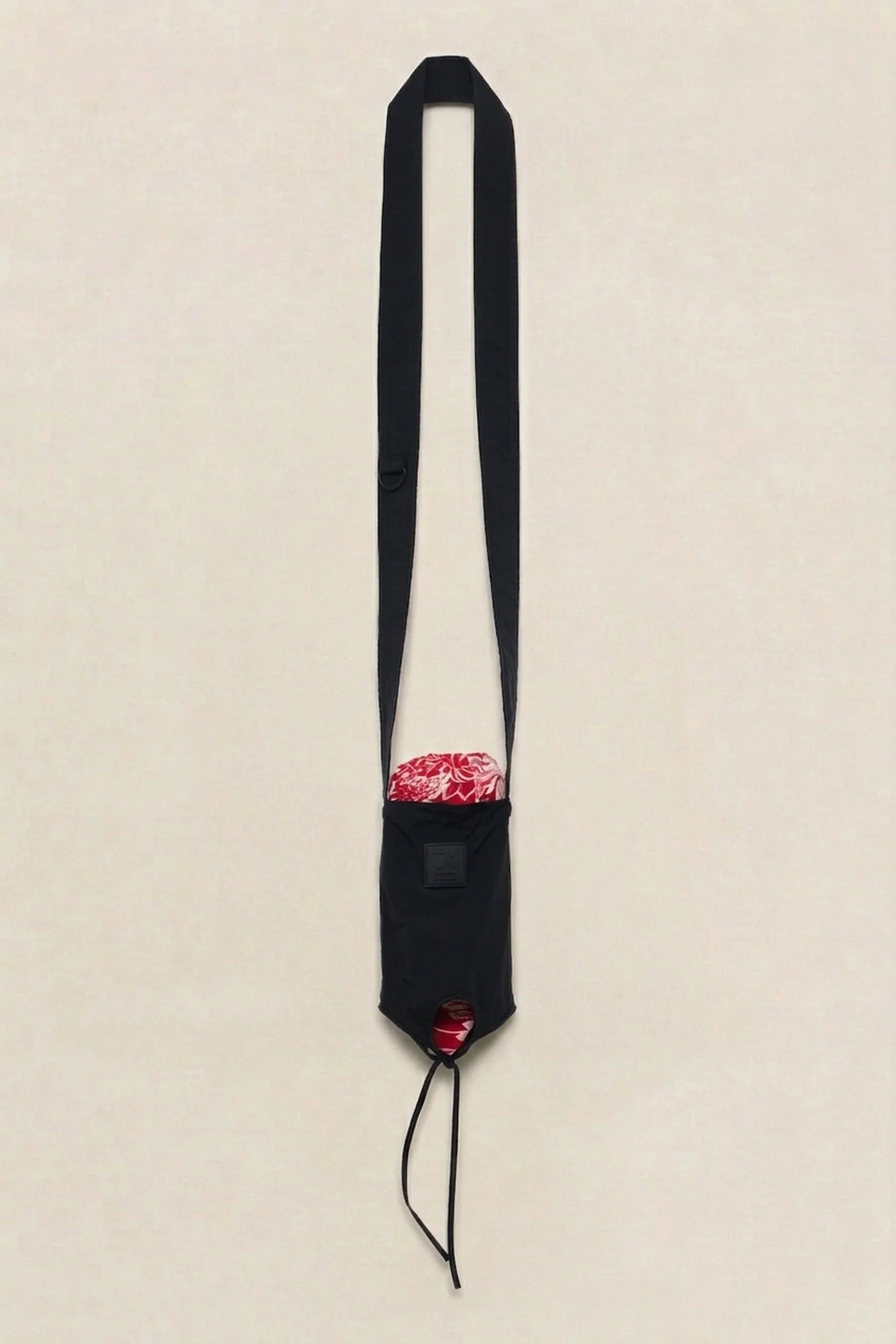 J.Kim Bukhara water bottle pouch in black, flat view of the crossbody bottle pouch