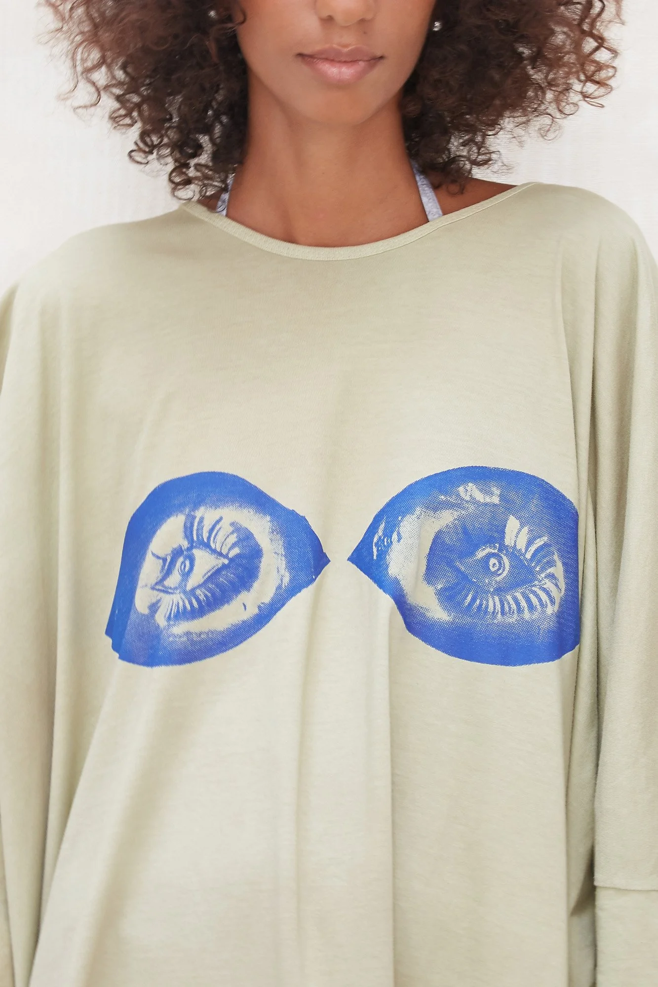 Intellectual Leisure Big Greek T-dress in green, close-up of the blue eyes print at the chest
