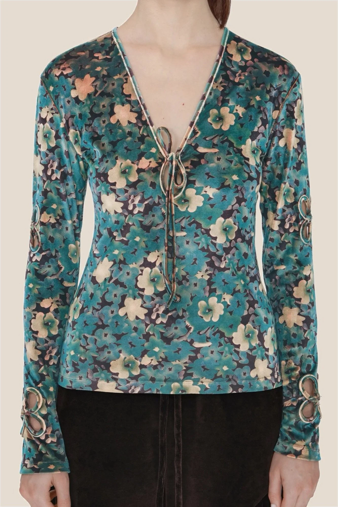 Detail J.Kim fitted long-sleeve velour top in a teal and caramel floral print, with a self-tie V-neck and petal-shaped cutouts on the upper sleeves and cuffs joined with metal rings