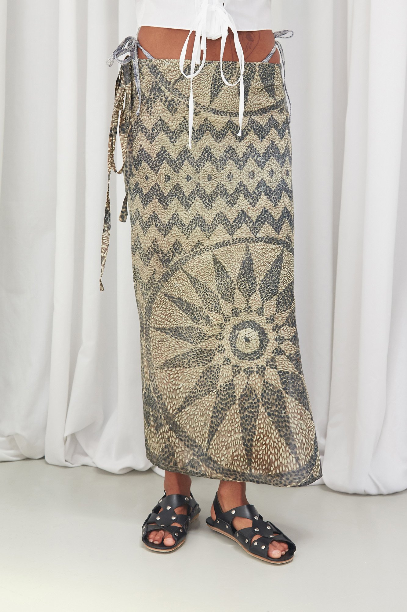Mouzahres wrap skirt in multi, close-up of the wrap tie fastening and geometric mosaic print detail