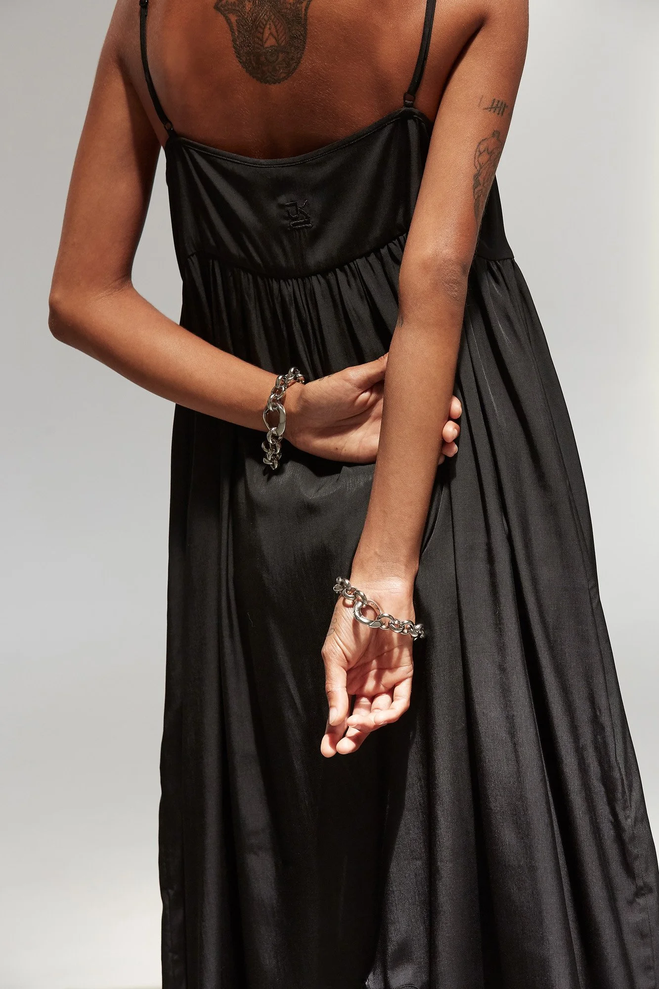 J.Kim petal chemise sundress in black, back view showing the open low back and flowing maxi silhouette