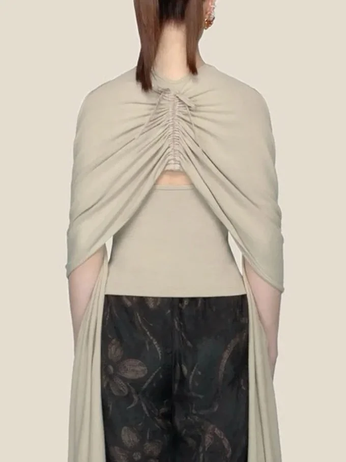 Detail of the back of J.Kim sleeveless halter knit top in light sage with an attached shawl draped over the shoulders