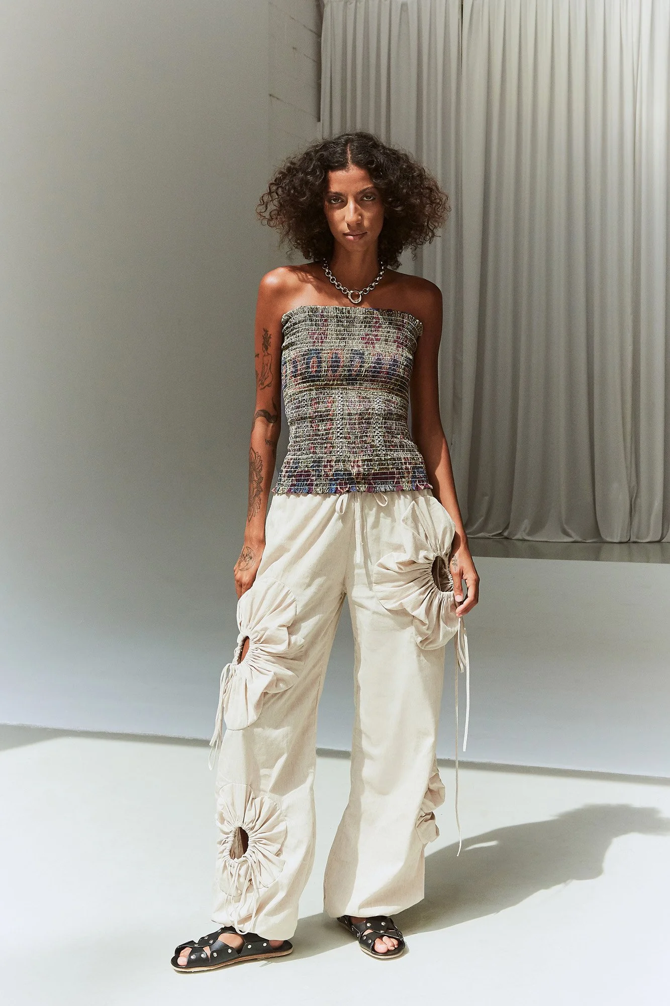 Mouzahres Hellebore bandeau top in multi, full-length front view of the strapless shirred bandeau top styled with J.Kim linen cream floral pants