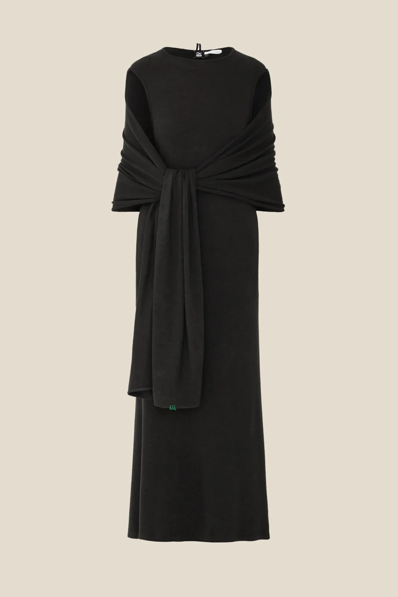 J.Kim sleeveless long halter knit dress in black with an attached shawl draped over the shoulders and tied in a long knot at the front, with green bead stitches at one end