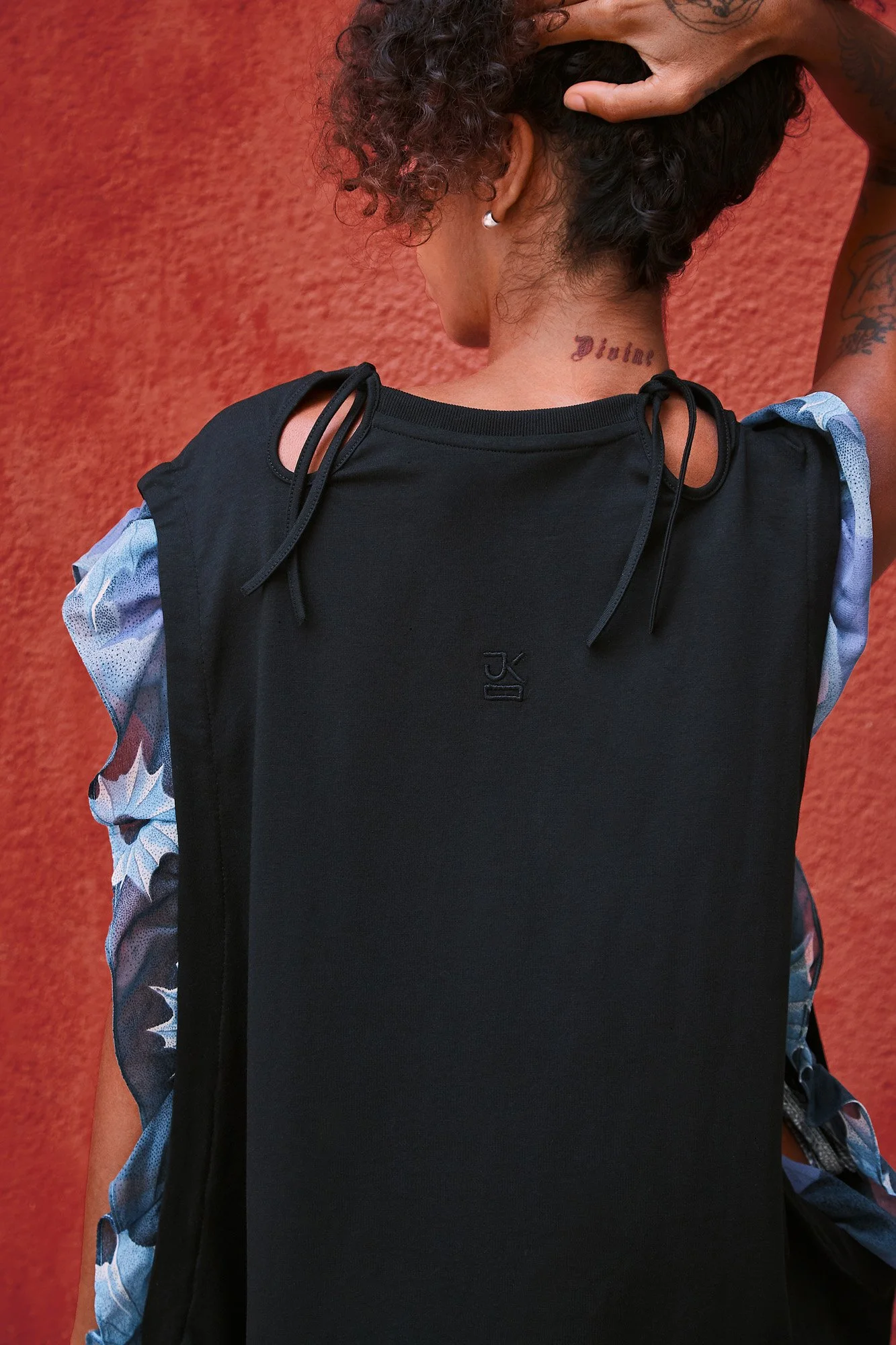 J.Kim Anechka petal t-shirt in black, back view showing the blue floral-print ruffled sleeves and neckline cut-out detail
