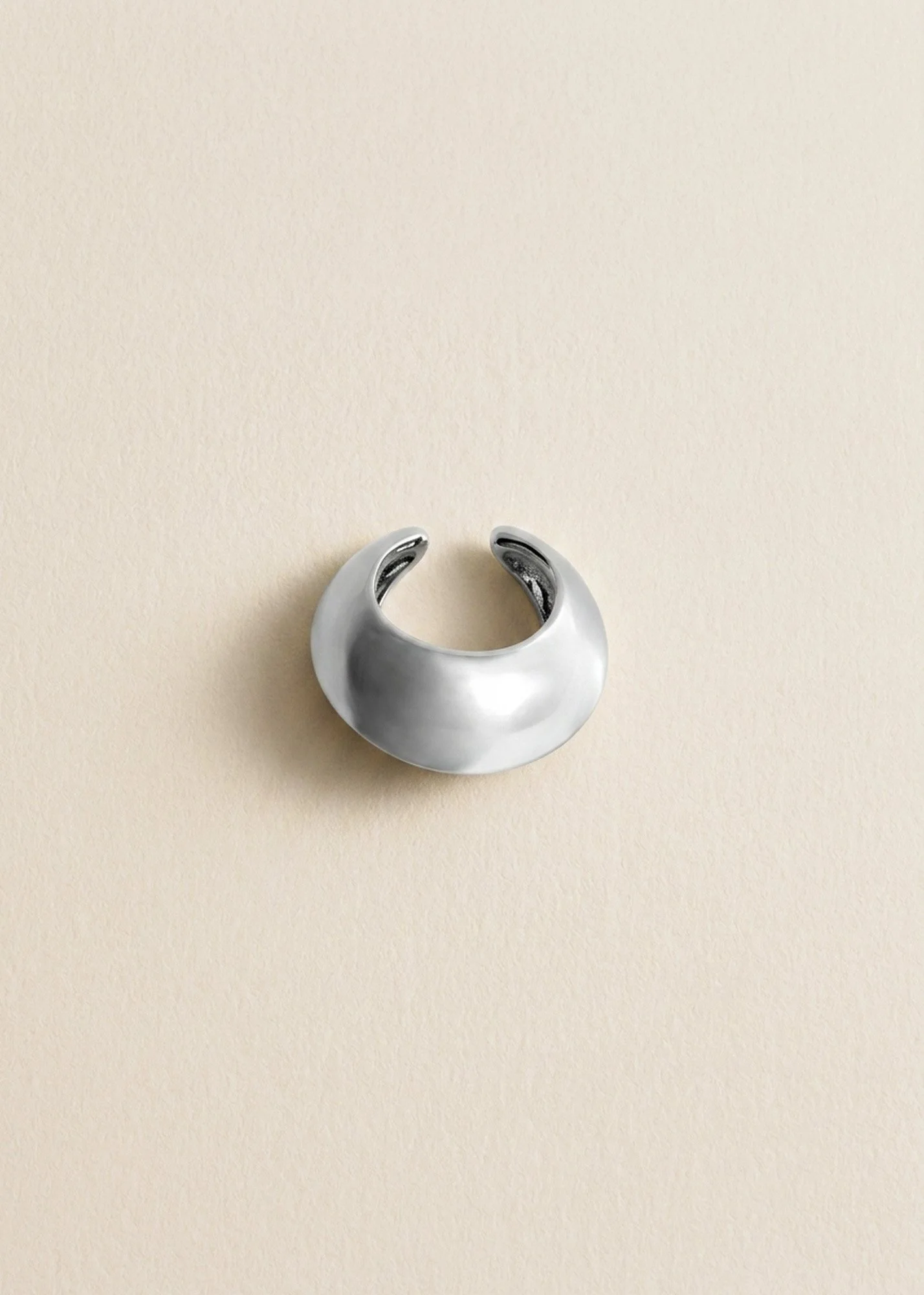 Florence Moorhead Lune ear cuff in silver,  of the sculptural ear cuff, photographed flat