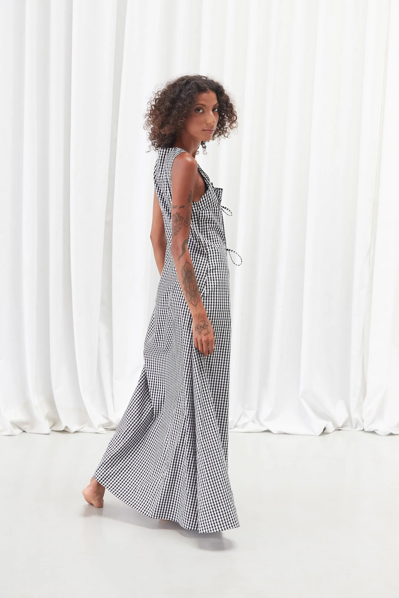 Intellectual Leisure Eirini dress in black and white check, full-length back view showing the sleeveless maxi silhouette