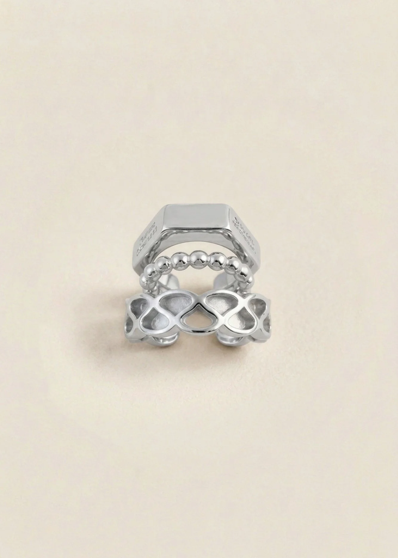 Front view of the Florence Moorhead x Solène Lescouët Collerette Ear Cuff showing its three stacked bands in polished palladium-dipped brass.