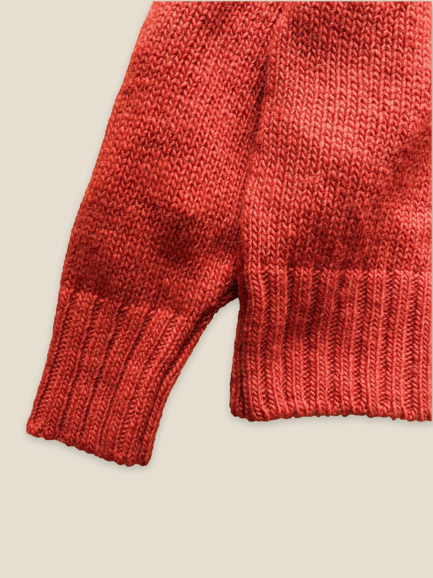 Close-up of the ribbed cuff and hem on the Floca Ringo Sweater in paprika Spanish wool