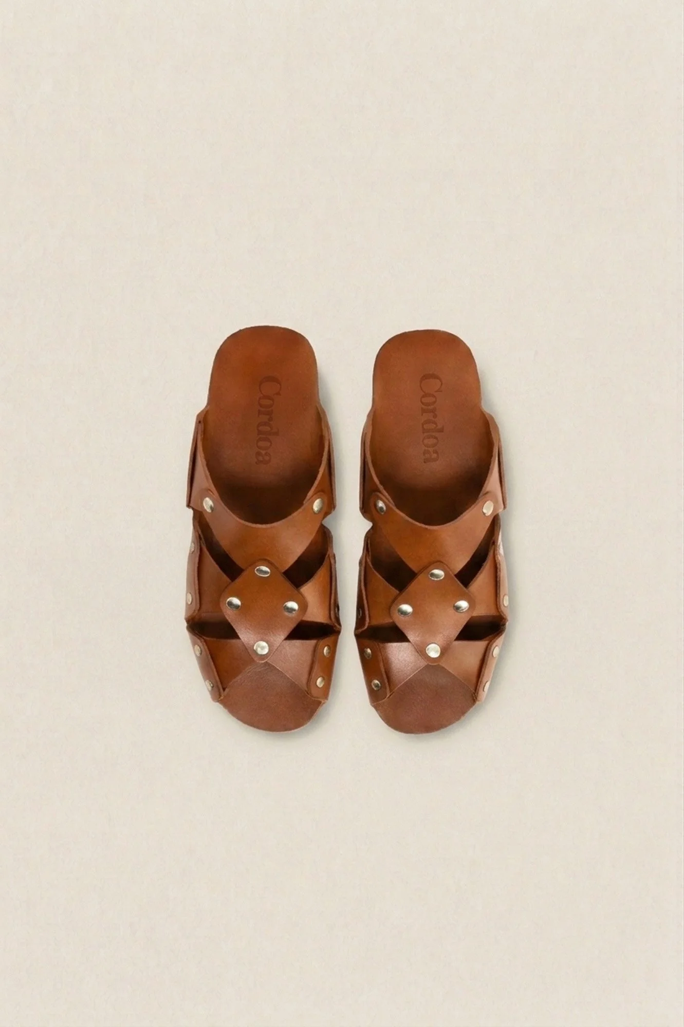 Cordoa Muscari sandal in brown, overhead view of the studded leather crossover straps