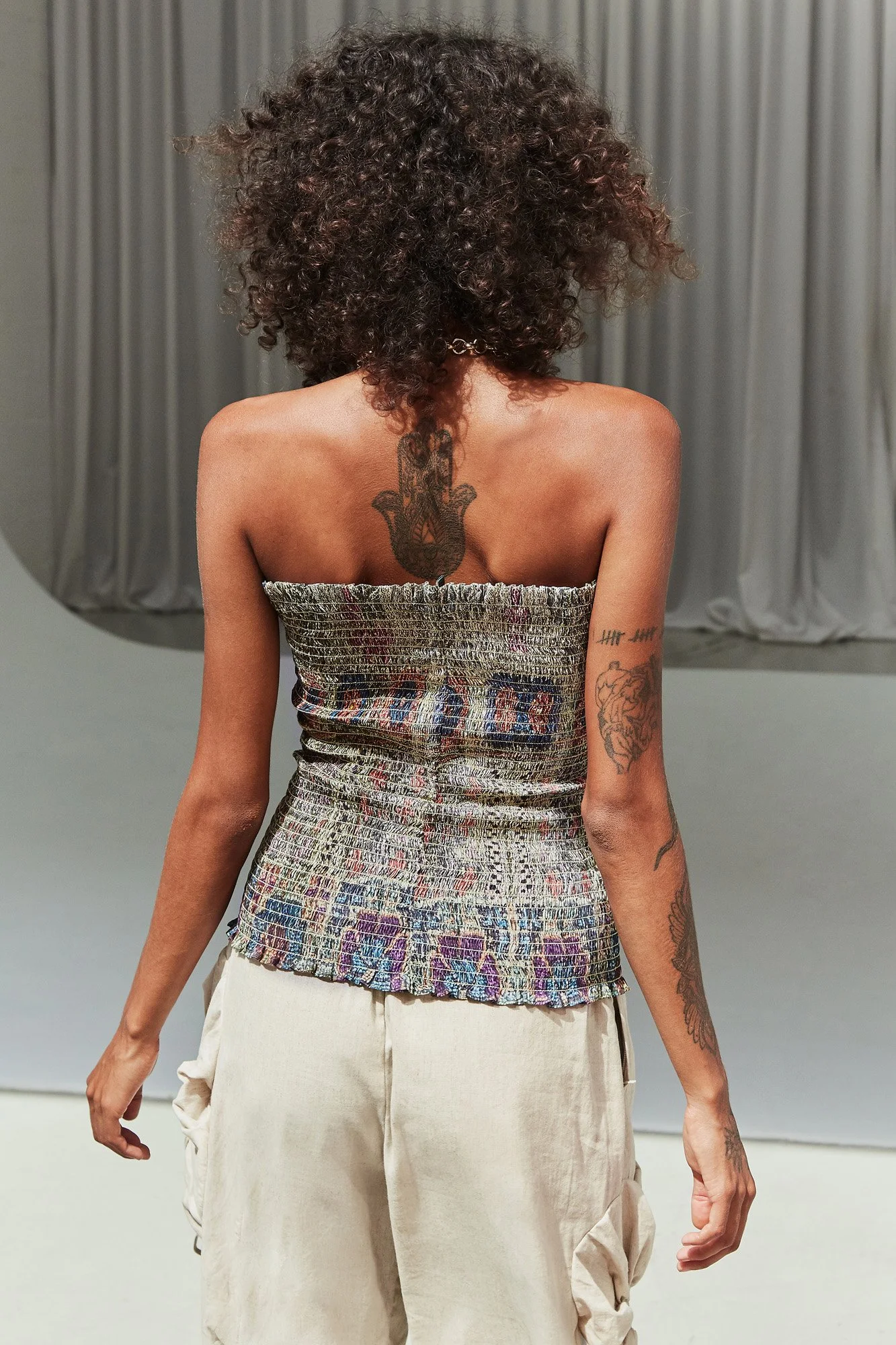 Mouzahres Hellebore bandeau top in multi, back view showing the strapless shirred cut and mixed ikat print