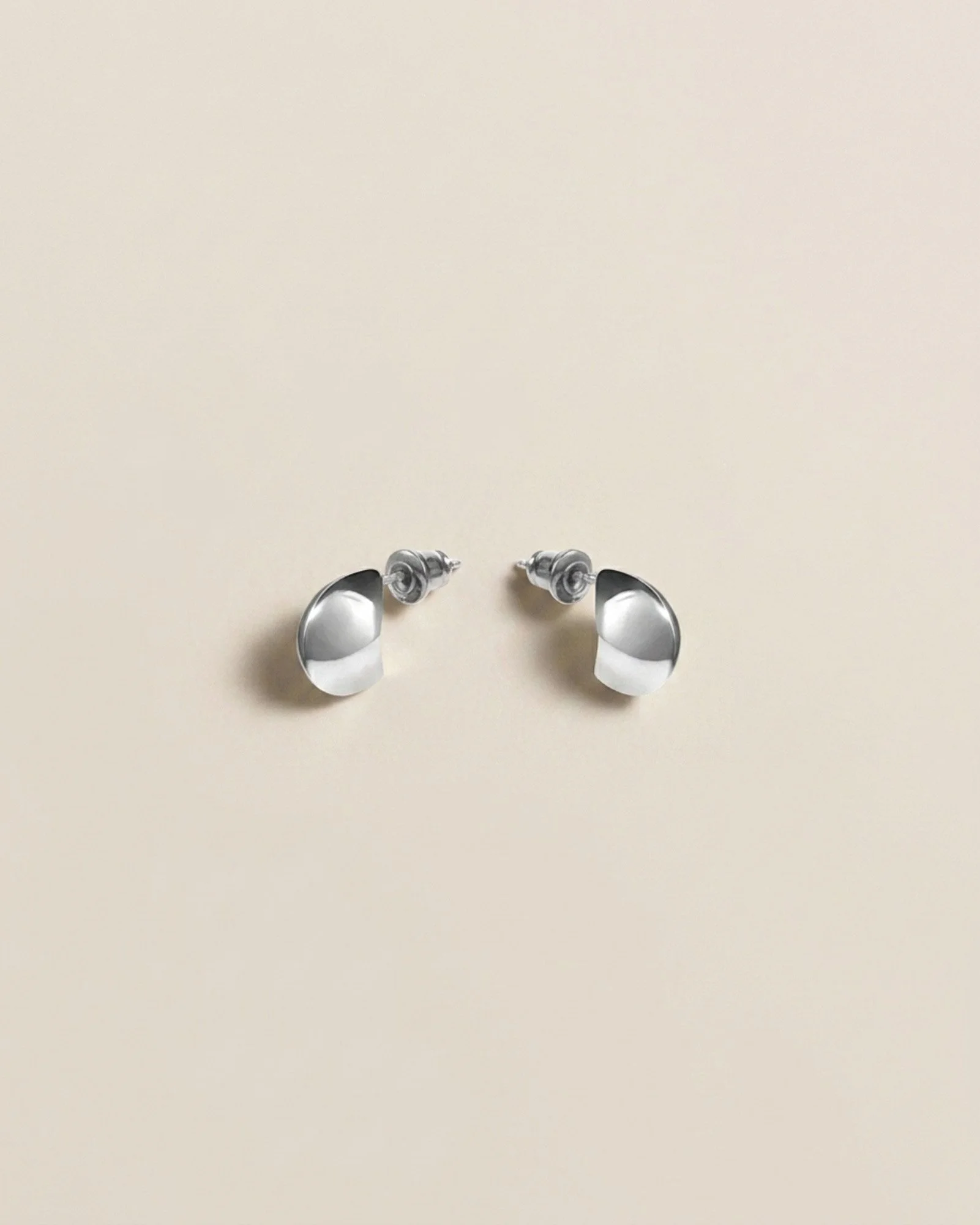 Florence Moorhead Petite Lune earring in silver, photographed flat