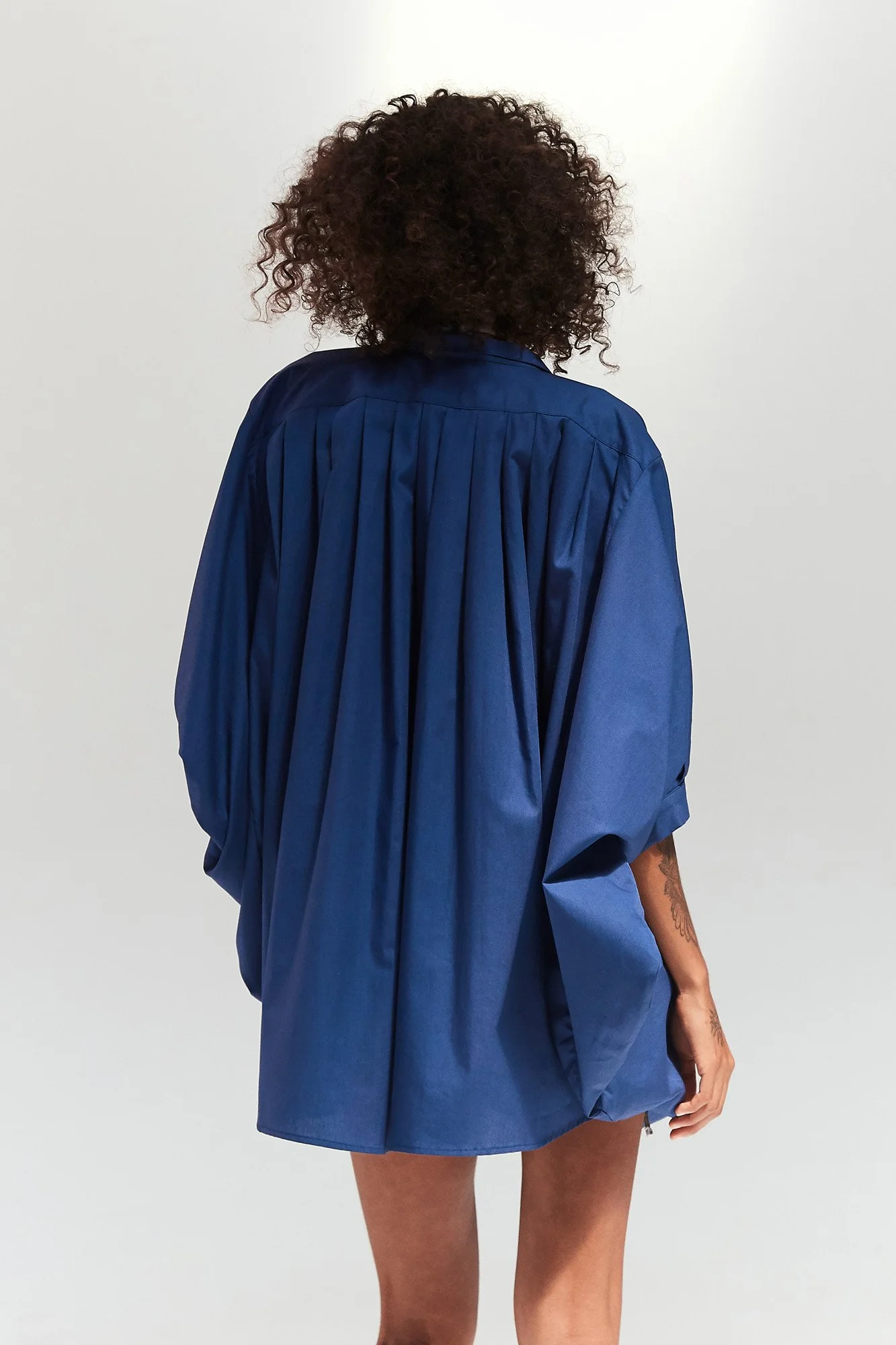 Intellectual Leisure Stella top in blue, back view showing the oversized gathered smock silhouette and elbow-length sleeves