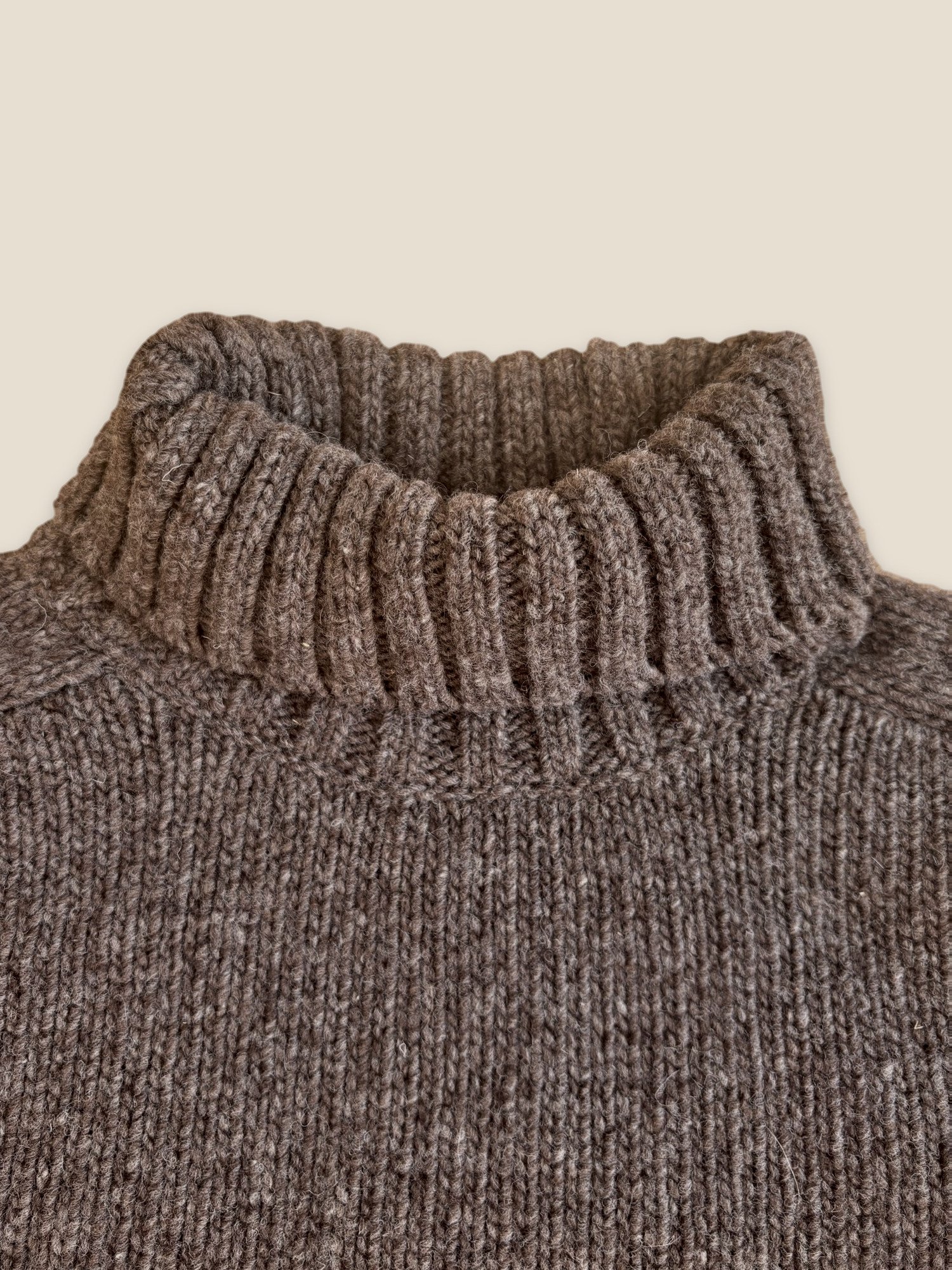 Close-up of the Woodsmoke Ringo Oversize Sweater by Floca with the ribbed turtleneck folded down.