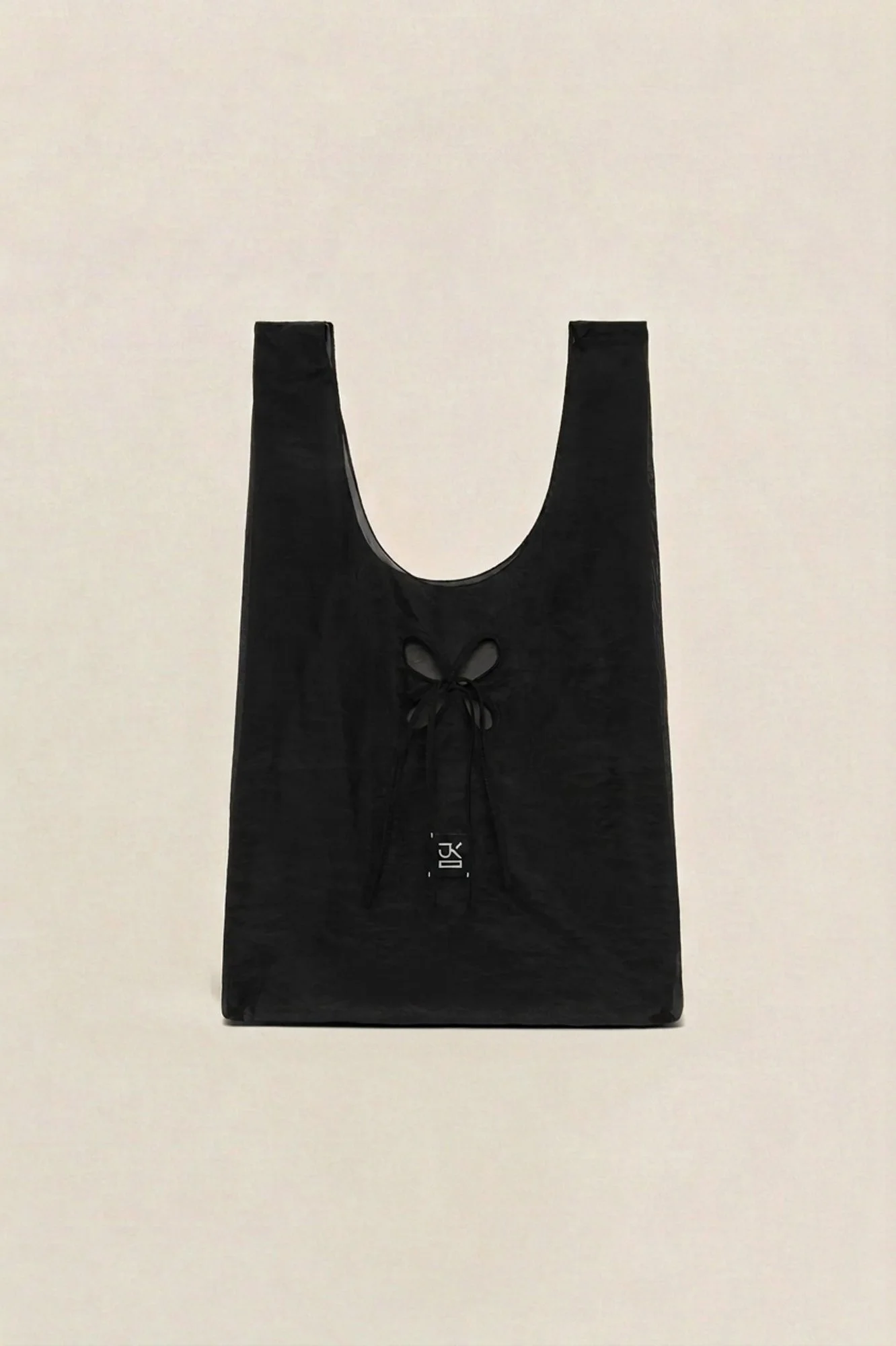 J.Kim petal tote in black, flat image of the sheer tote bag with petal cut-out detail