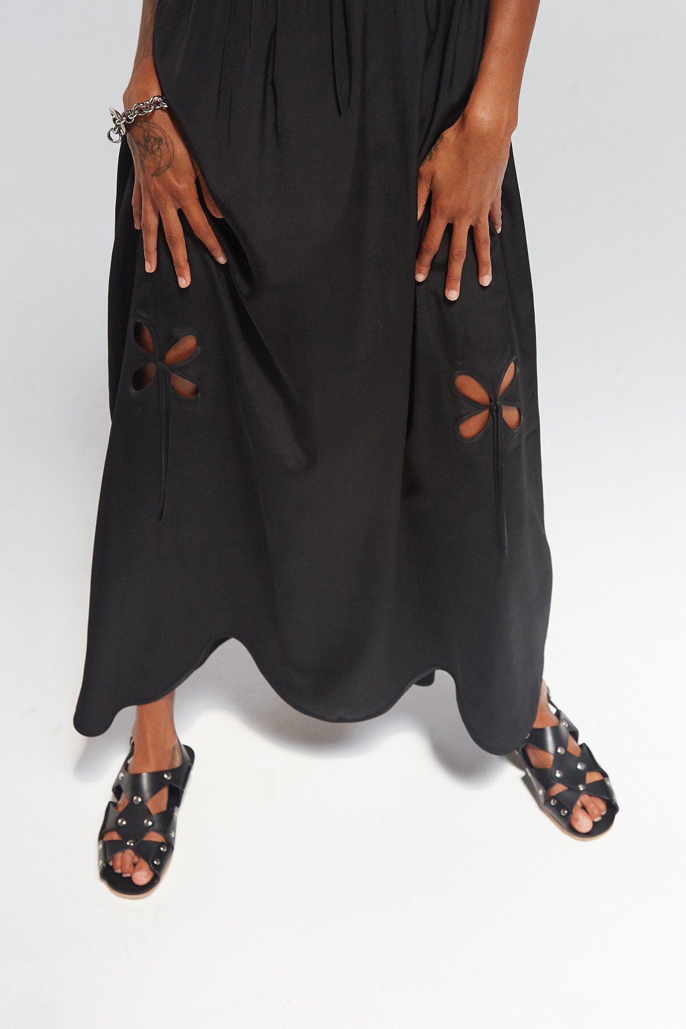 J.Kim petal chemise sundress in black, close-up of the petal cut-out detail at the hem, styled with Cordoa black sandals