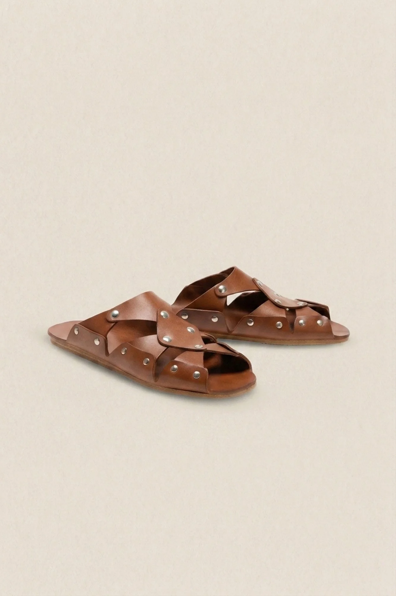 Cordoa Muscari sandal in brown, three quarters view of the studded leather crossover straps