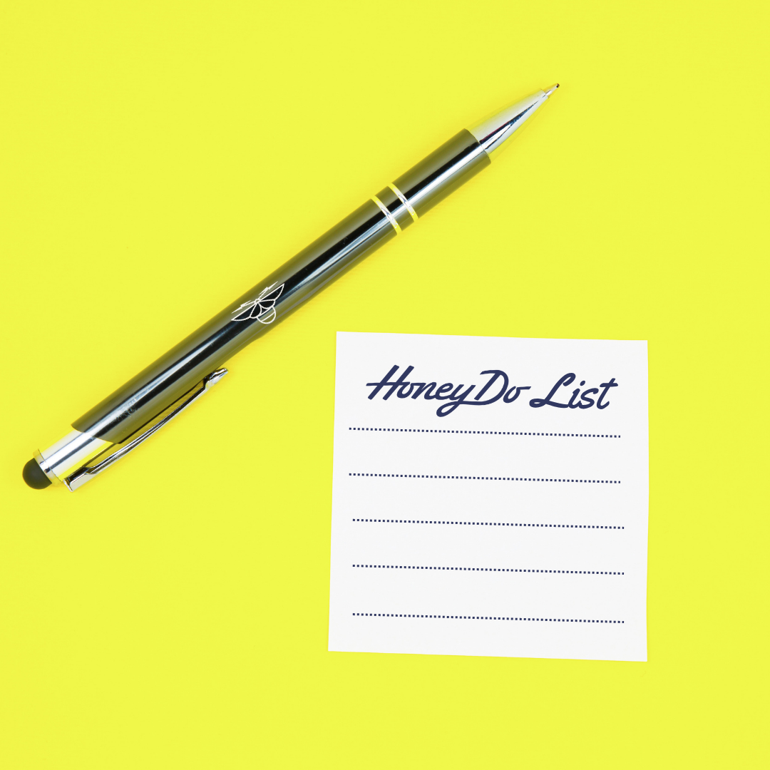 A black and silver Pen next to a white Honey Do List sheet with dotted lines on a bright yellow background.