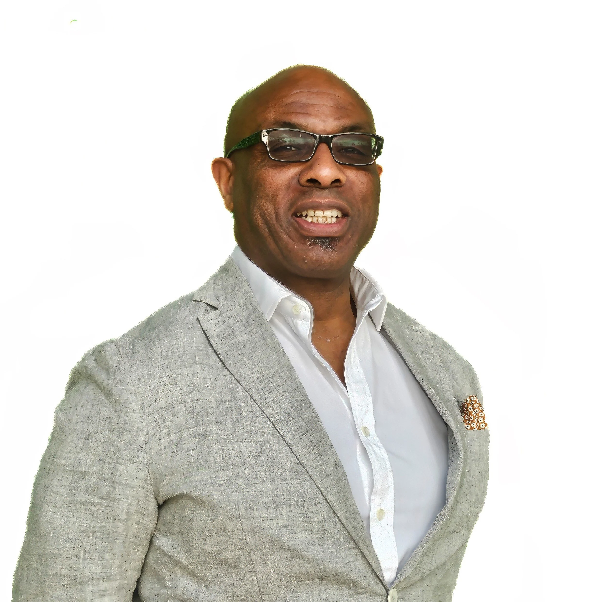 Close-up of a smiling man wearing glasses, a light gray blazer, and a white shirt, standing against a plain white background.
