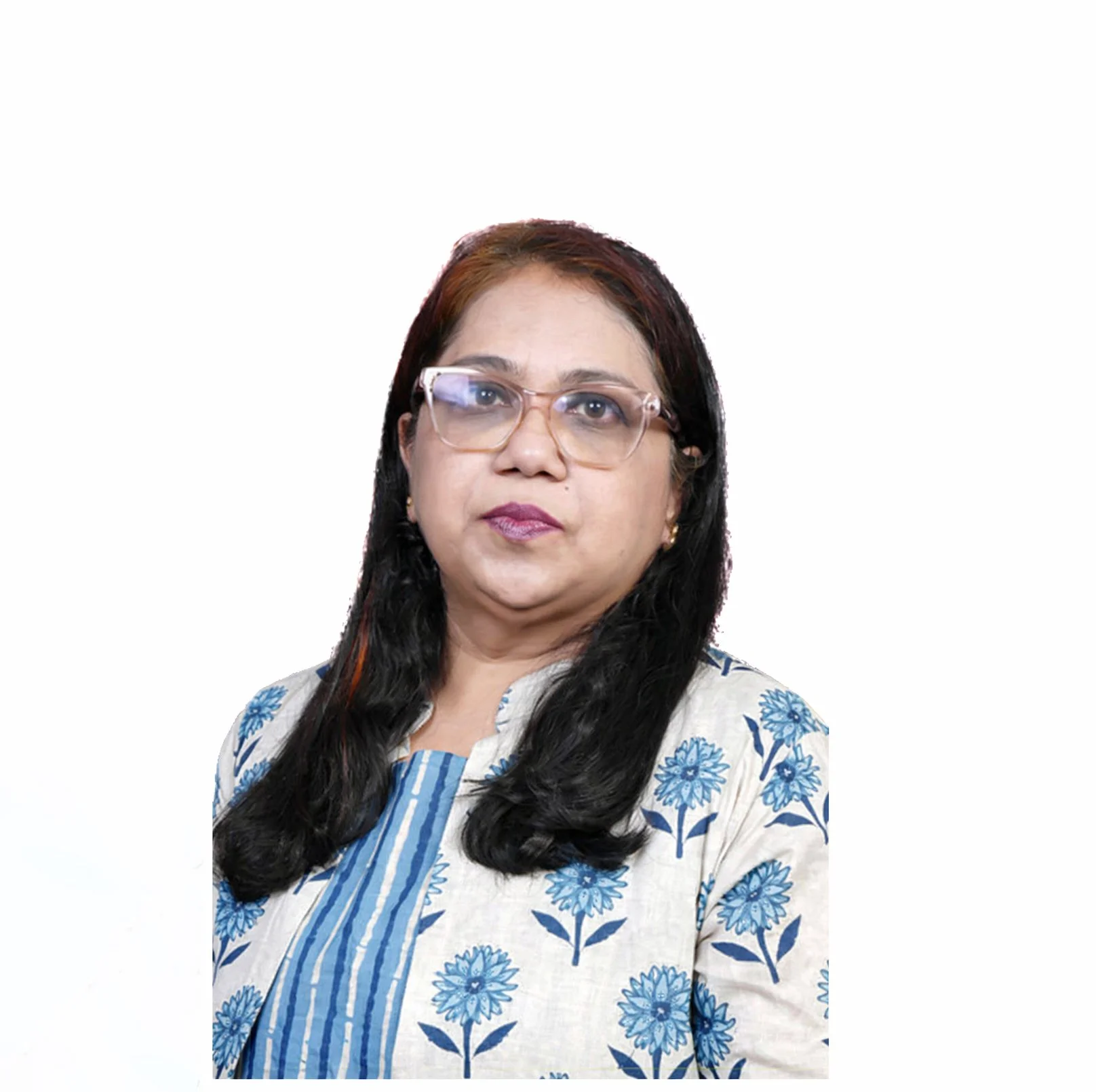A woman with long black hair, wearing glasses and a blue and white floral-patterned kurta, stands against a white background.