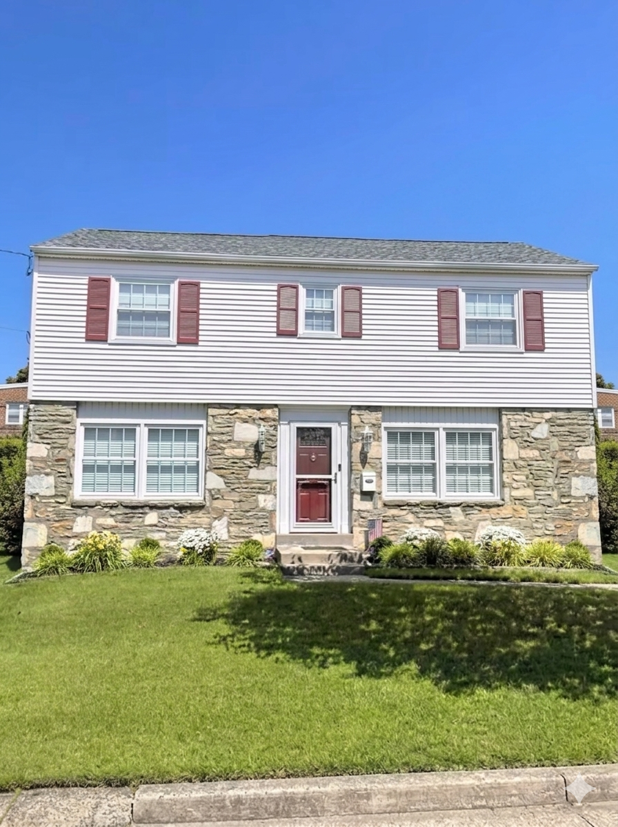 Front of a two-story home with light siding, red shutters, a stone facade, and red entry door.