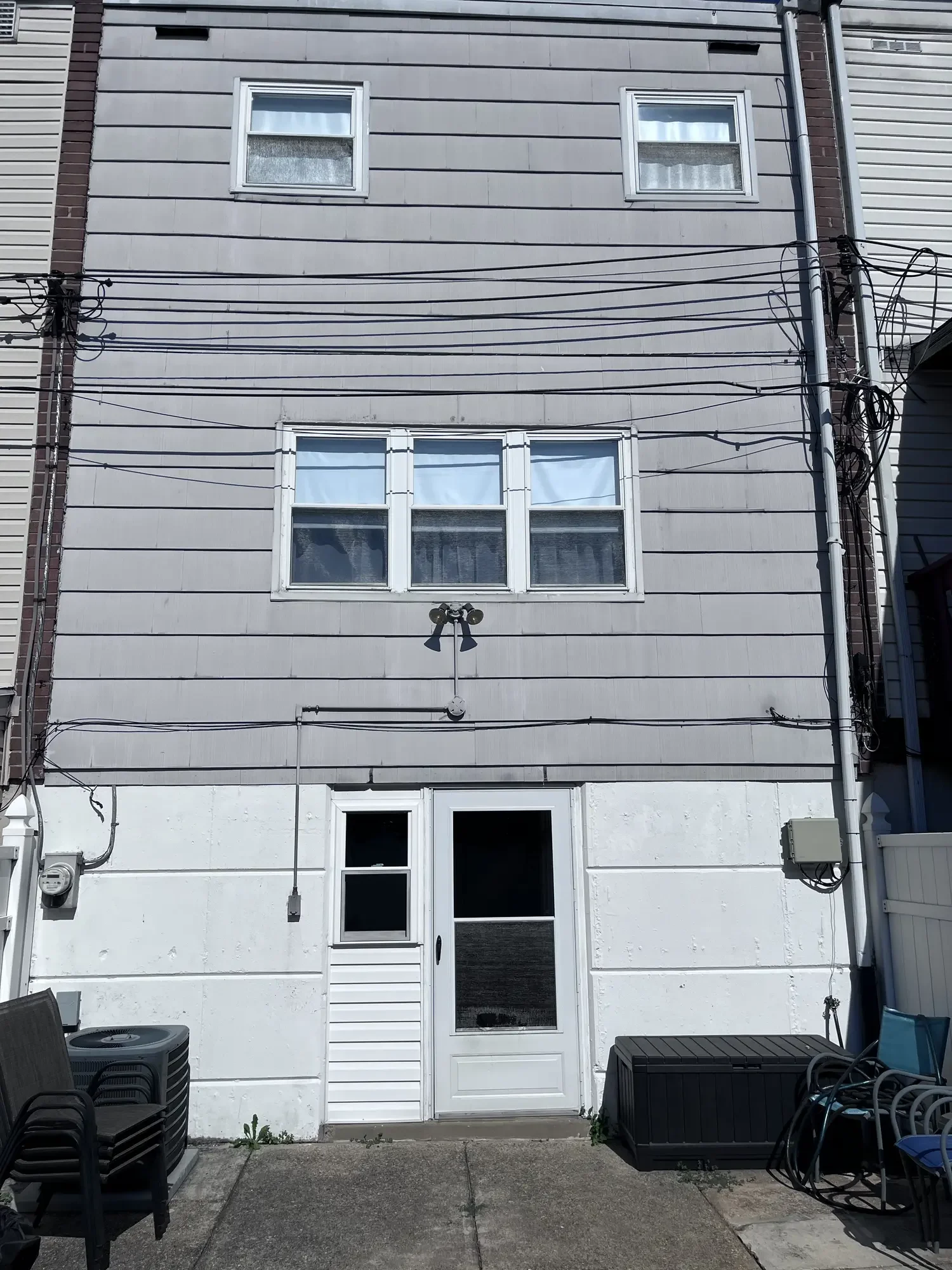 Rear exterior before blue siding and window renovation work began.