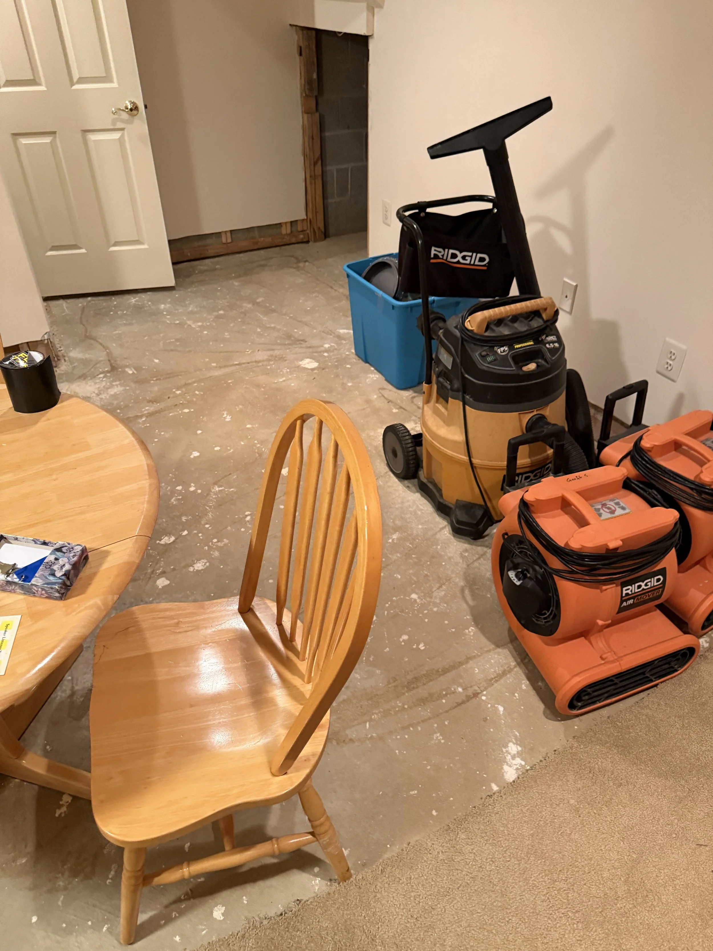 Floor preparation equipment positioned on an exposed concrete subfloor.