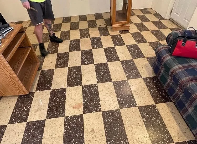 Brown and cream checkerboard flooring before replacement.