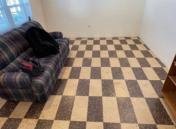 Room with brown and cream checkerboard flooring before replacement.