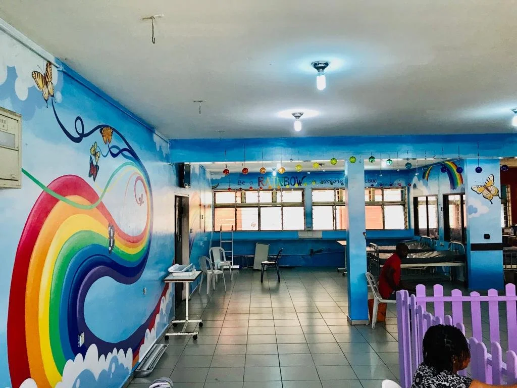 An image of a colorful pediatric ward with rainbows and butterflies 