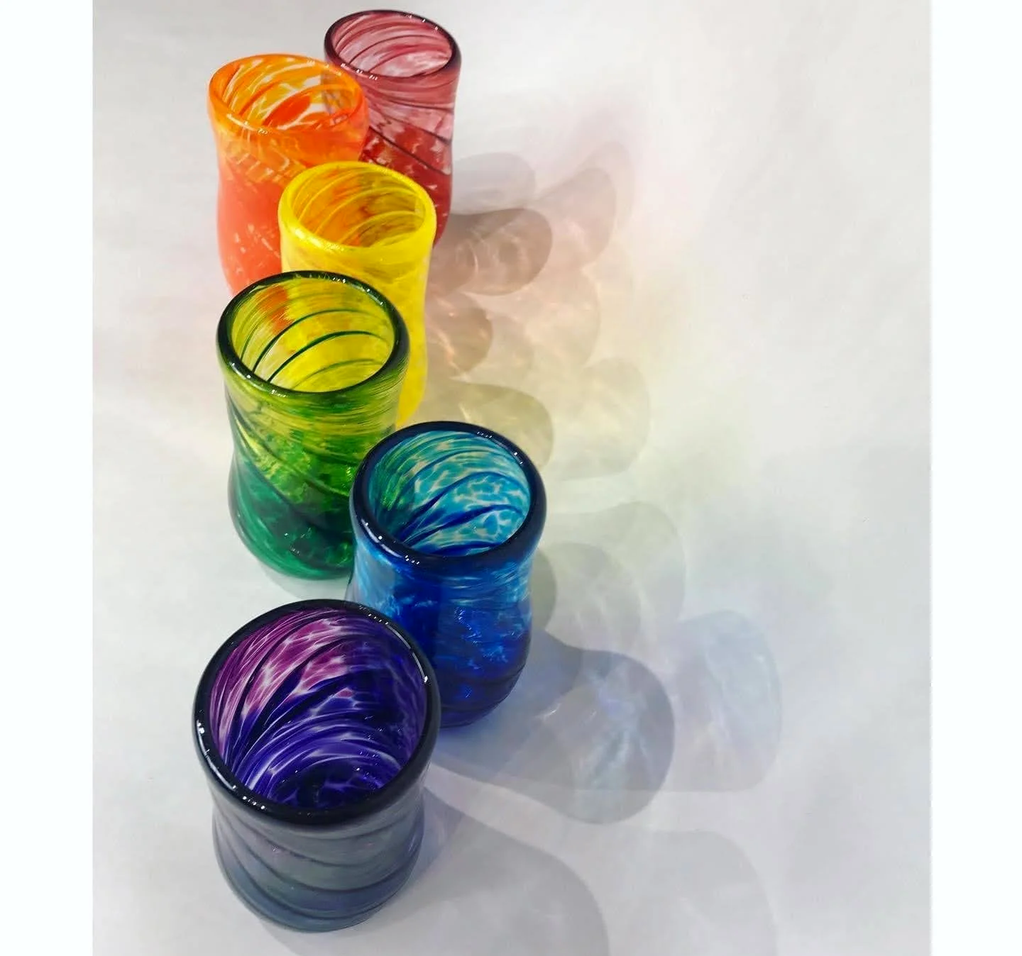 handblown drinking glasses in red, orange, yelow, green blue and purple