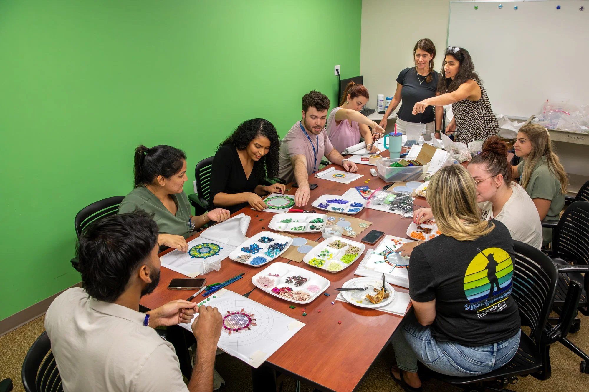 A group of nurses working on a collaborative mosaic 