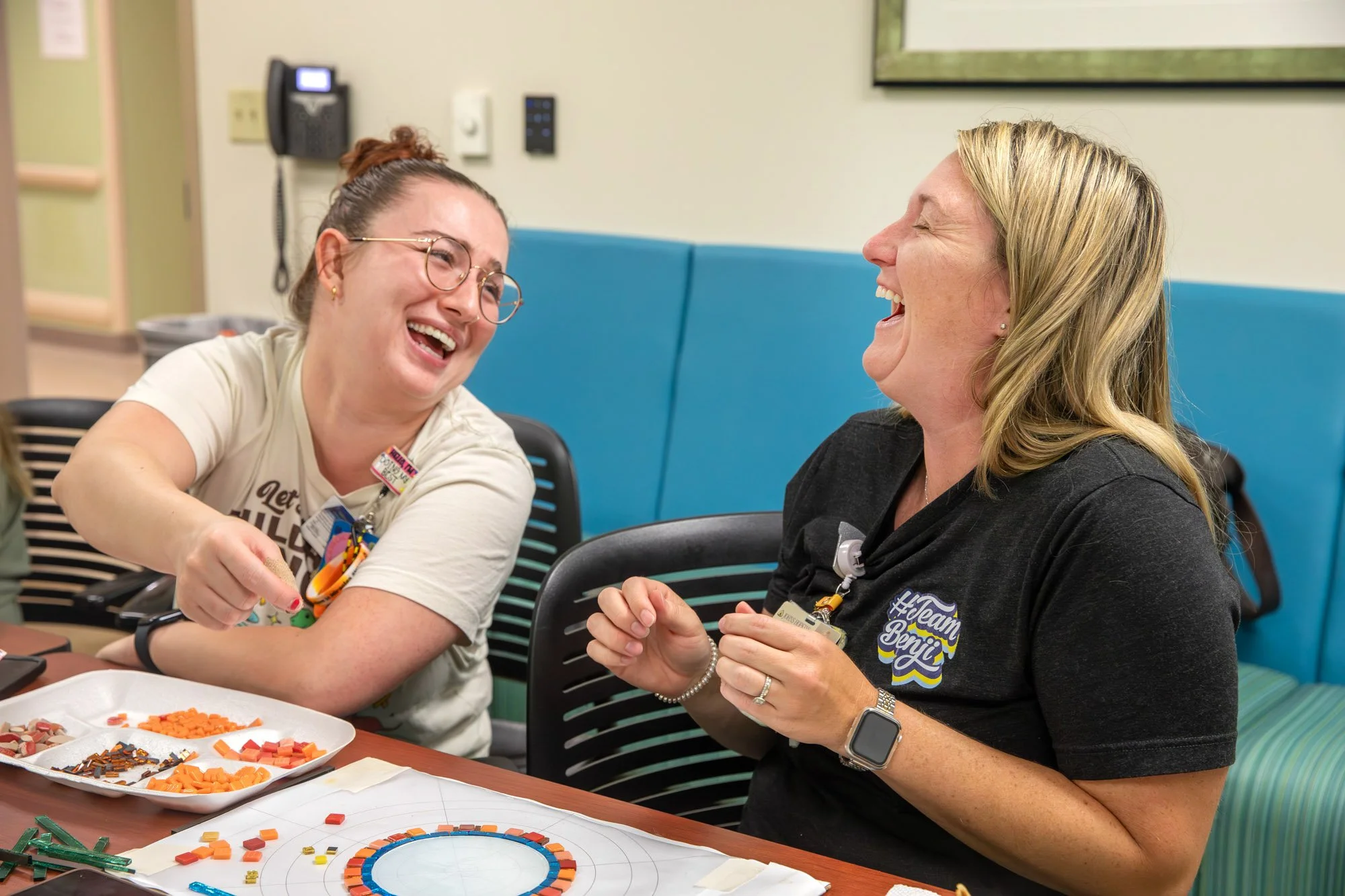 Nurses laugh while working on mosaics 