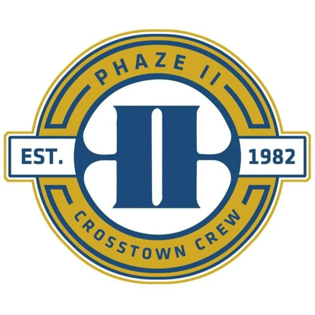 Circular logo with a large blue II in the center, surrounded by yellow and blue text that reads "PHÁZE II" at the top, "CROSTOWN CREW" at the bottom, and "EST. 1982" on a blue banner across the middle.