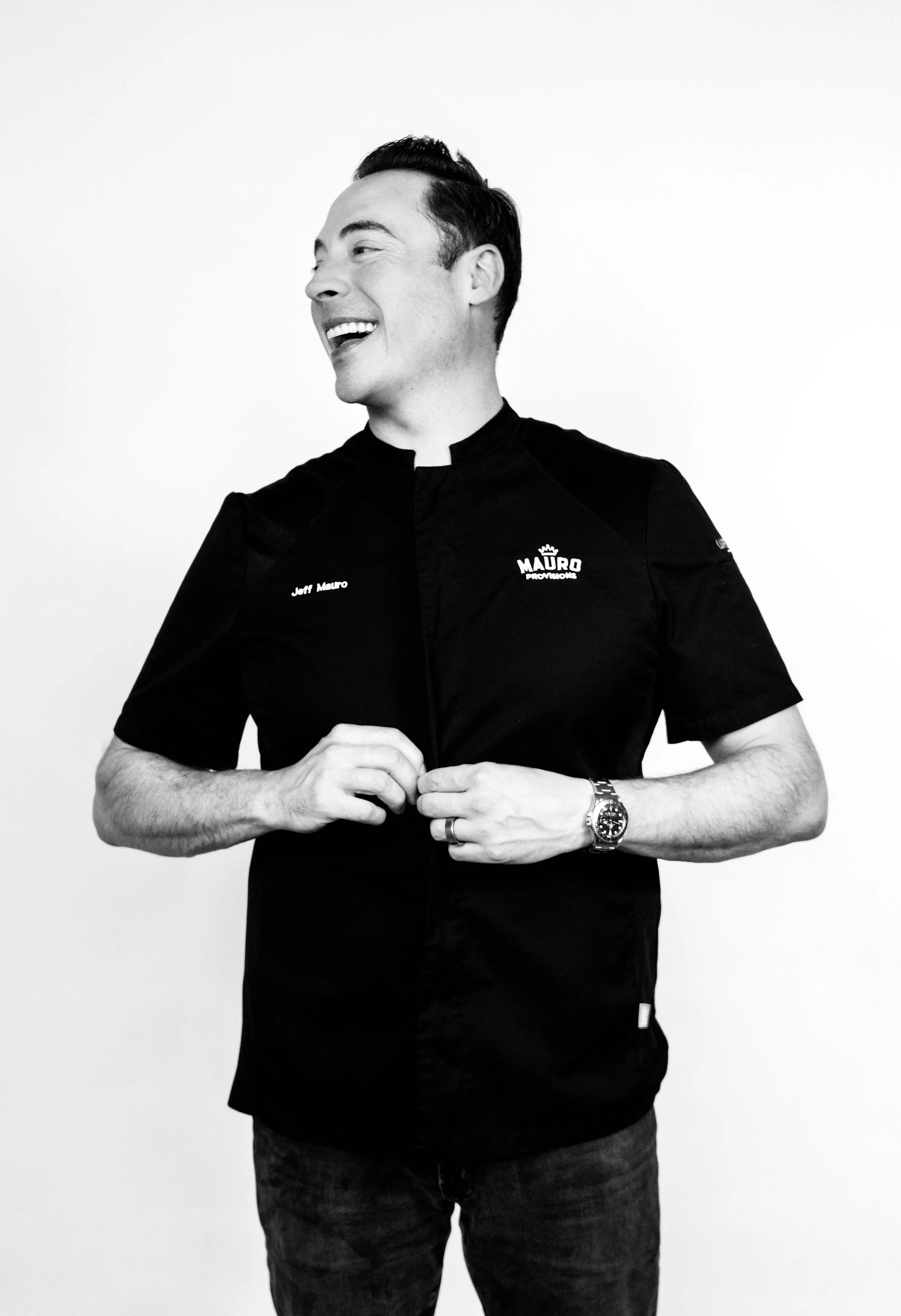 Black-and-white photo of Chef Jeff Mauro standing against a white background.