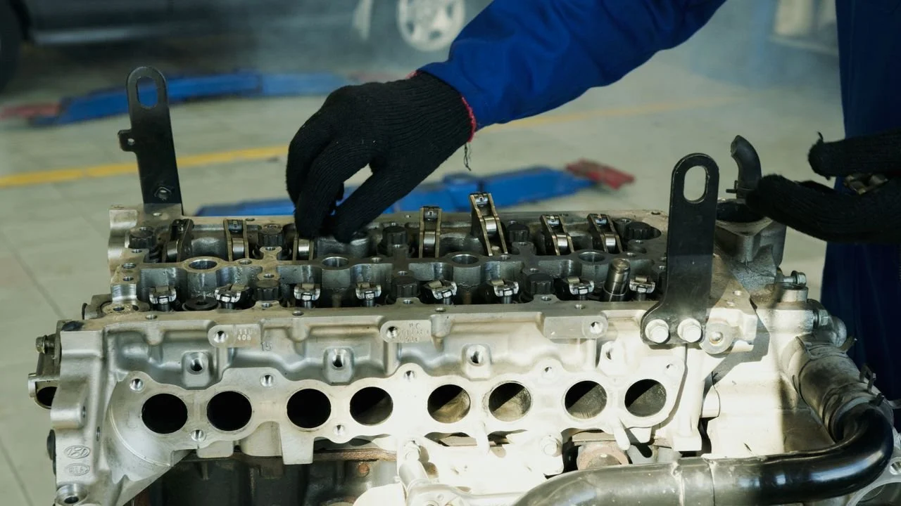 Master-tech mechanic working on a Jeep engine outside the vehicle