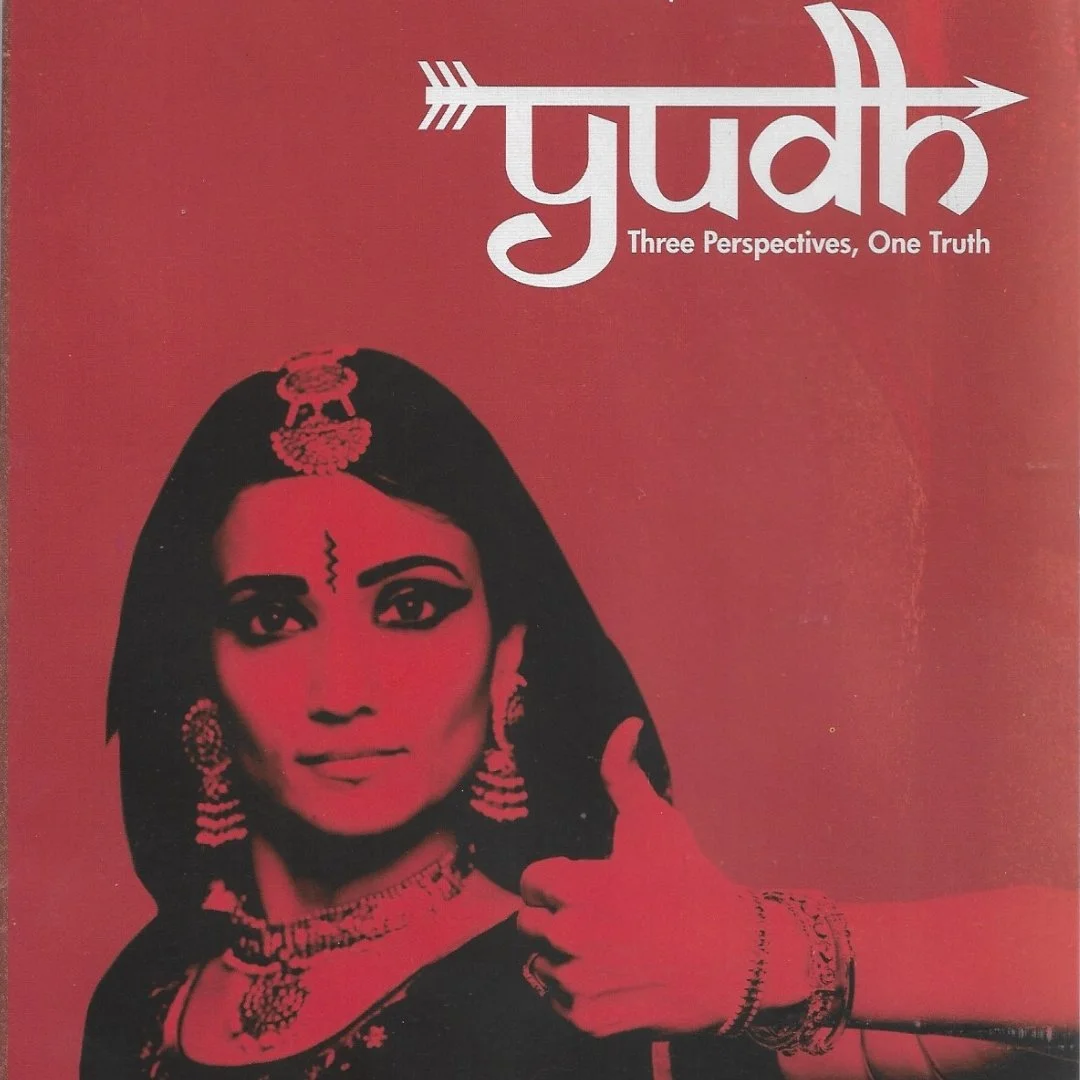 A red background with a black and white photograph of a woman dressed in traditional Indian attire and jewelry, giving a thumbs-up. The word 'pudk' in stylized font with an arrow, and the subtitle 'Three Perspectives, One Truth'.