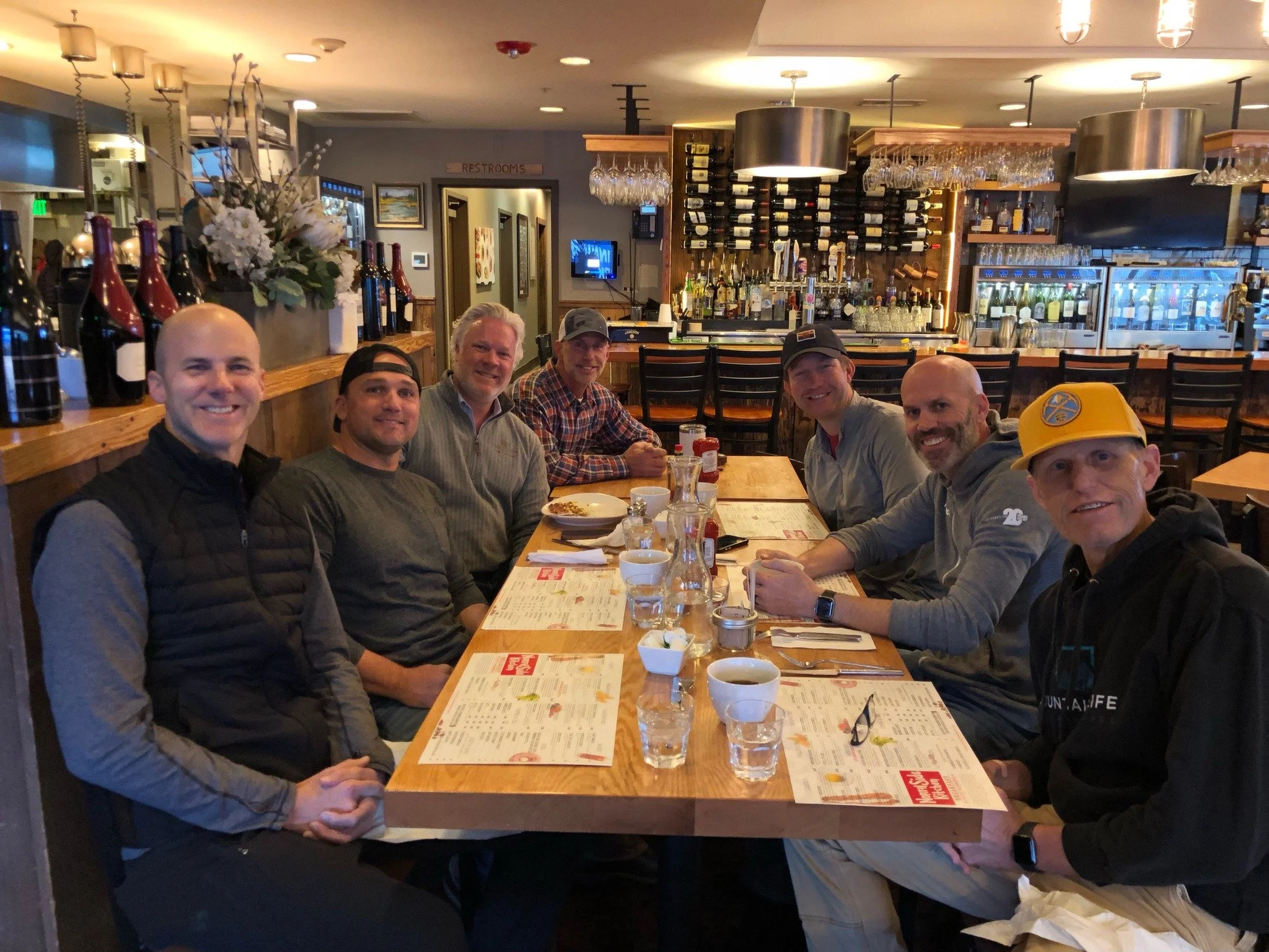 Men's discipleship small group meeting together at a restaurant for weekly session