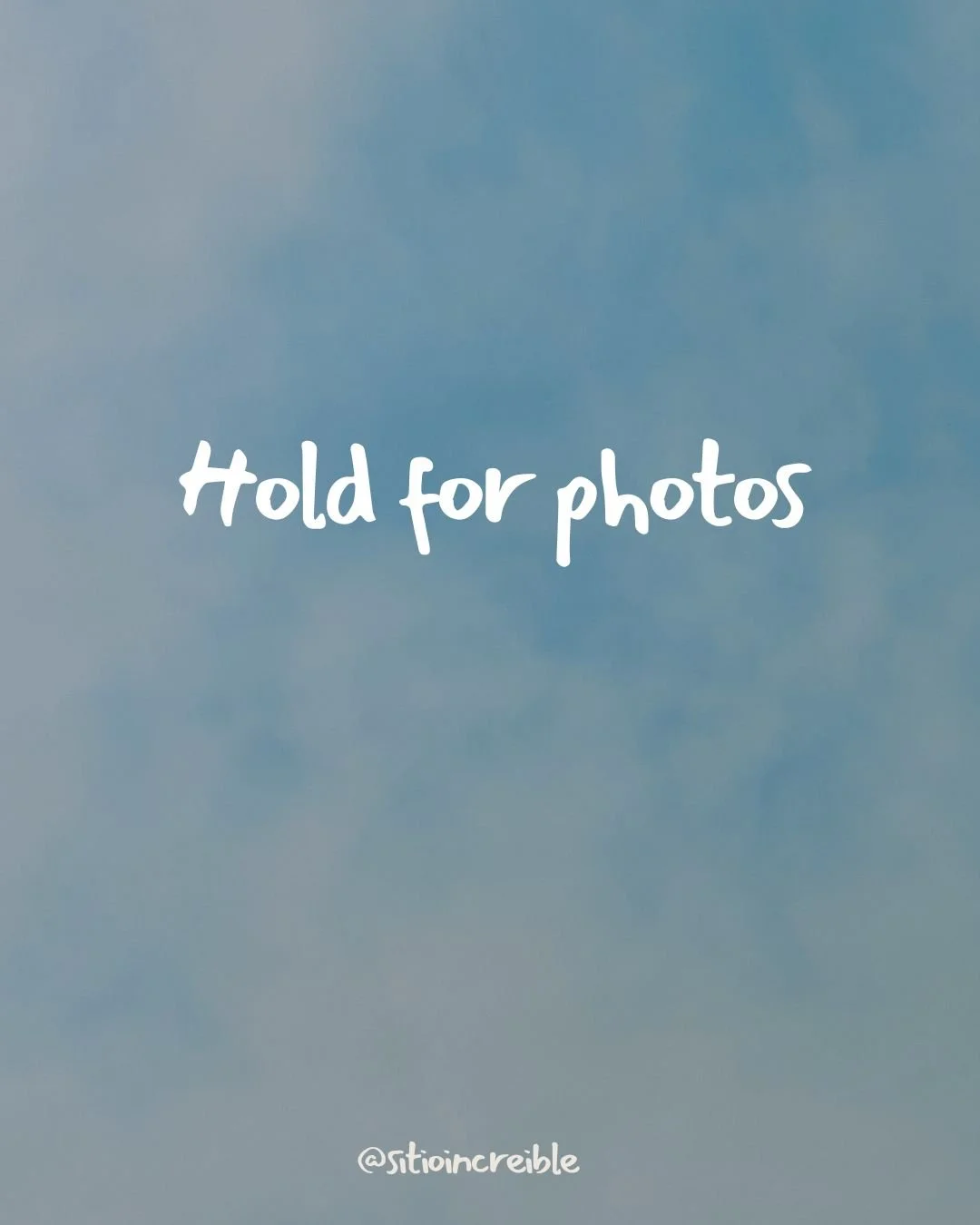 Blue sky with white clouds, with the overlay text 'Hold for photos' and a signature '@stoincredible' at the bottom.