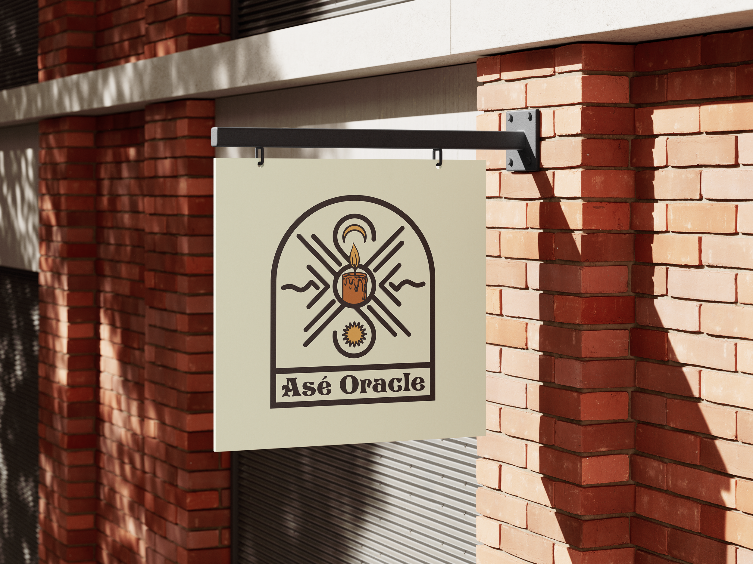 A sign hanging on a metal arm attached to a brick building. The sign has a logo featuring a candle and text that reads 'Asé Oracle'.