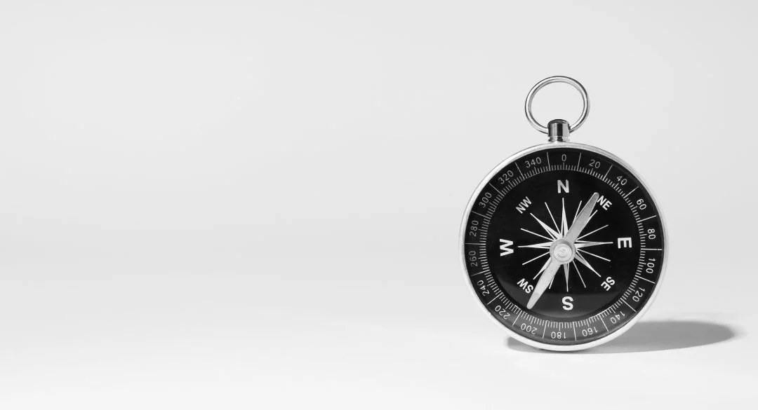 Compass pointing northeast, representing guidance and navigating life transitions.