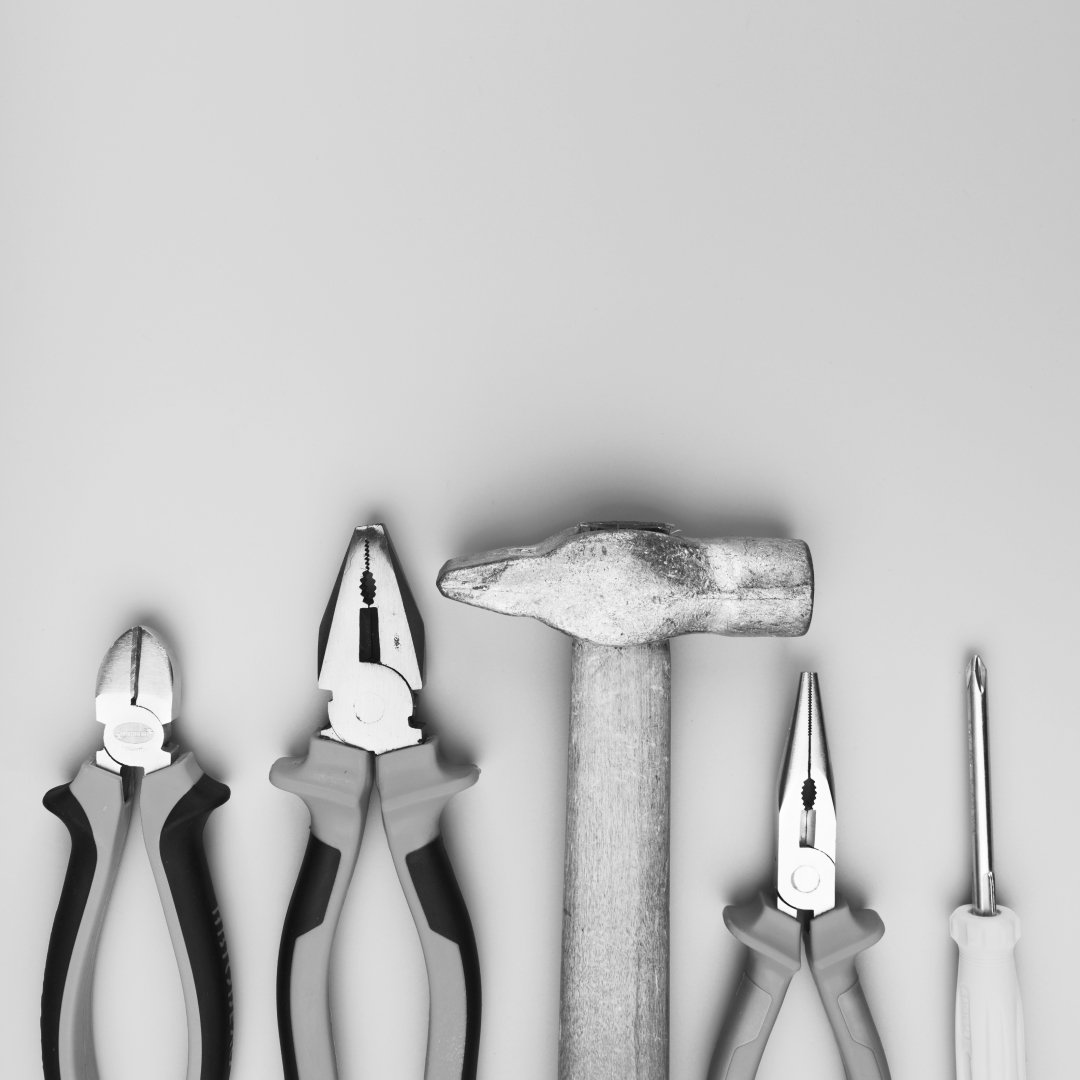 A set of tools arranged neatly, representing practical tools and methods used in coaching workshops