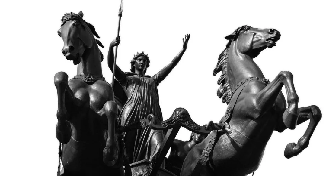 Statue of a figure leading a chariot pulled by two horses, symbolising strength and leadership