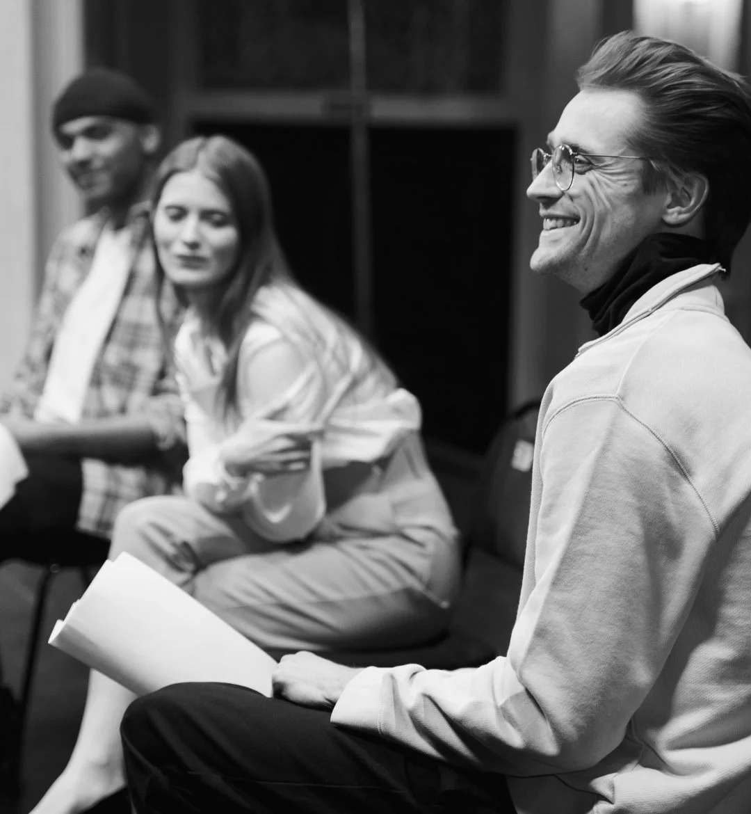 mall group engaged in a discussion during rehearsals