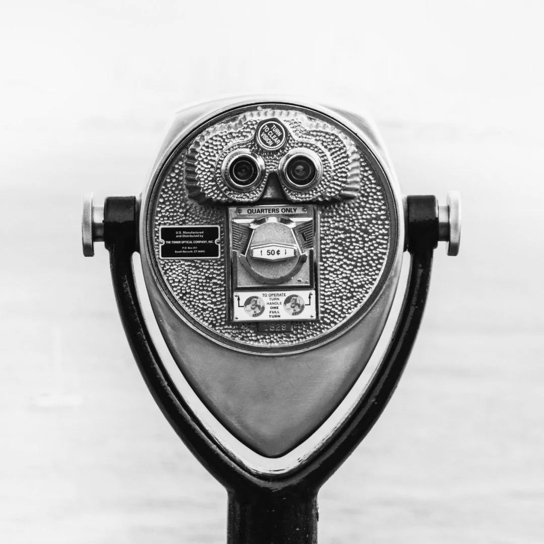 Coin-operated binocular viewer, representing clarity, focus, and long-term vision in leadership